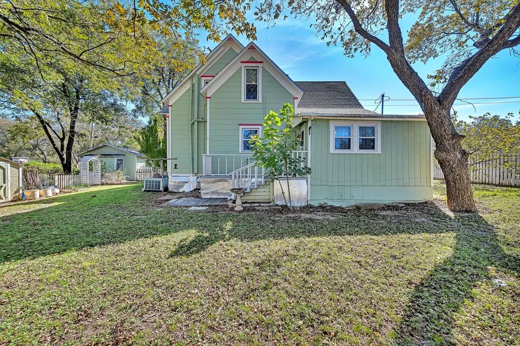 Rear view of property featuring a shingled roof