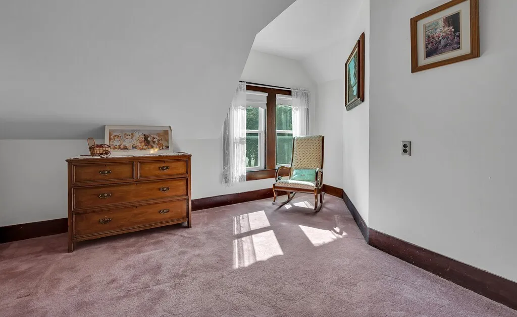 Sitting room with lofted ceiling and carpet floors
