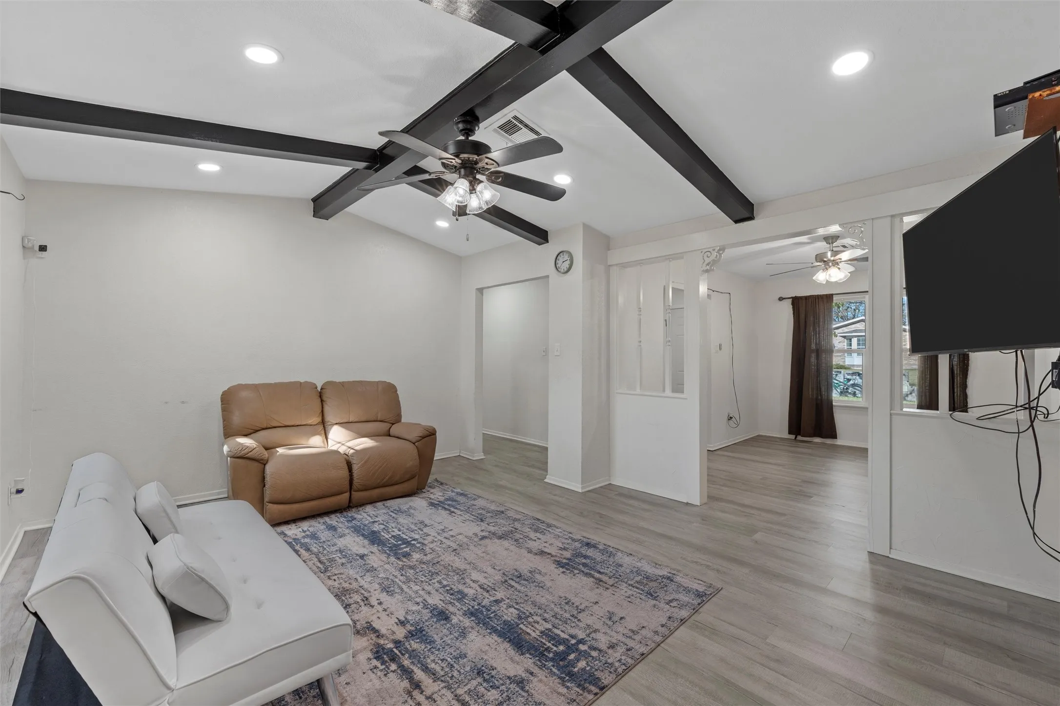 Living area featuring light wood-style flooring, recessed lighting, and a ceiling fan