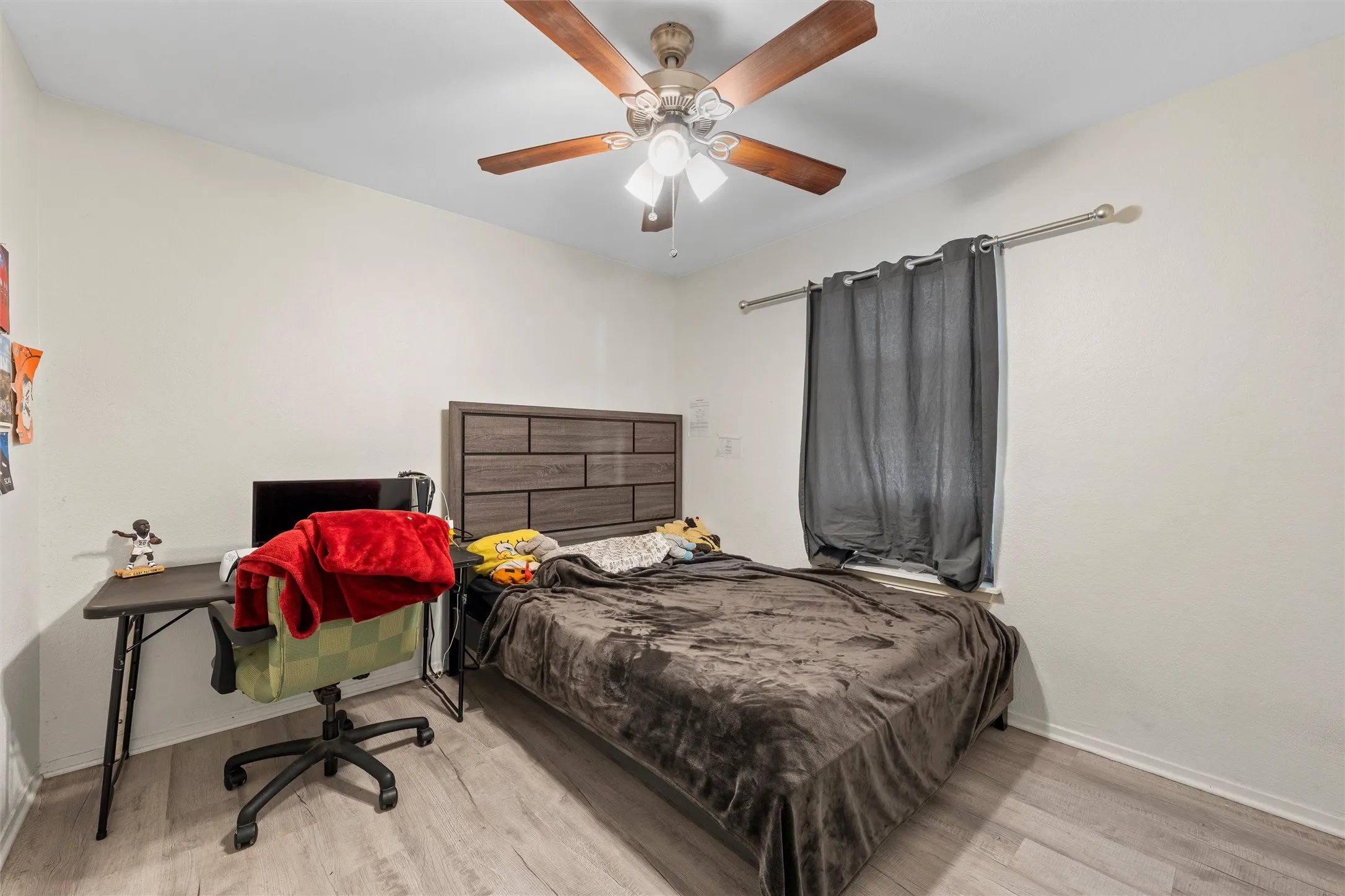 Bedroom featuring wood finished floors and a ceiling fan
