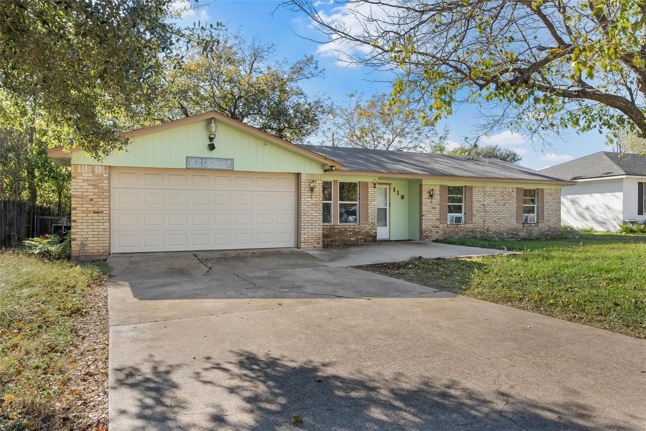 Ranch-style house with brick siding, concrete driveway, and an attached garage