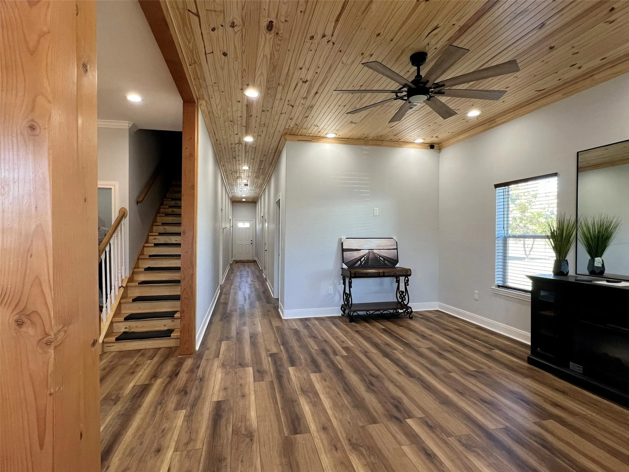 Hall featuring recessed lighting, crown molding, stairway, dark wood-style flooring, and wooden ceiling