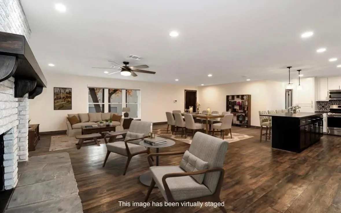 Living room with dark wood finished floors, a ceiling fan, a brick fireplace, and recessed lighting