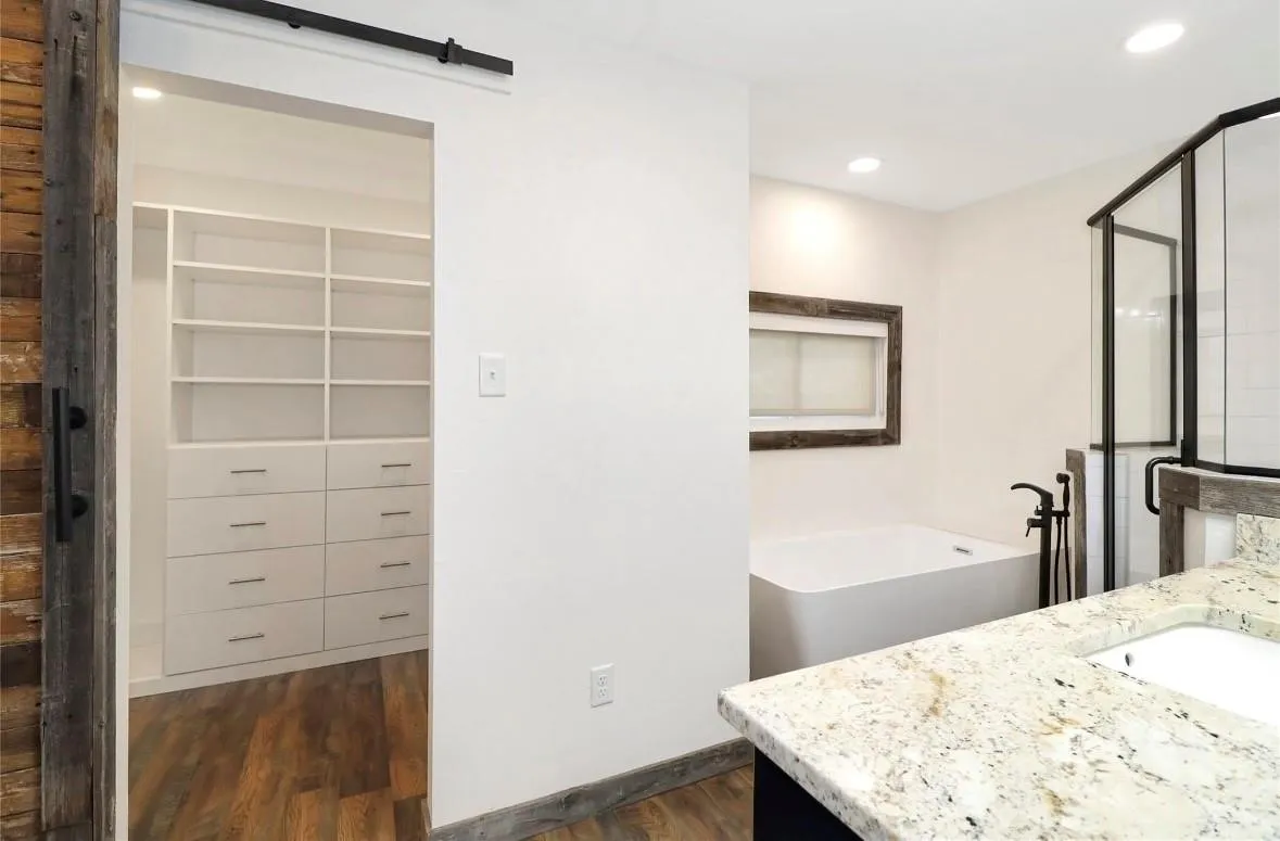 Bathroom with a soaking tub, dark wood-style flooring, vanity, a shower stall, and recessed lighting