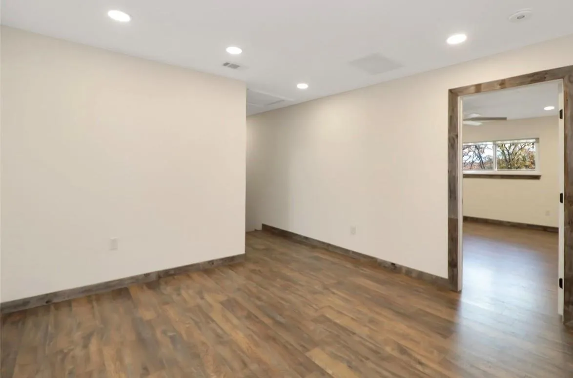 Unfurnished room featuring recessed lighting and dark wood-type flooring