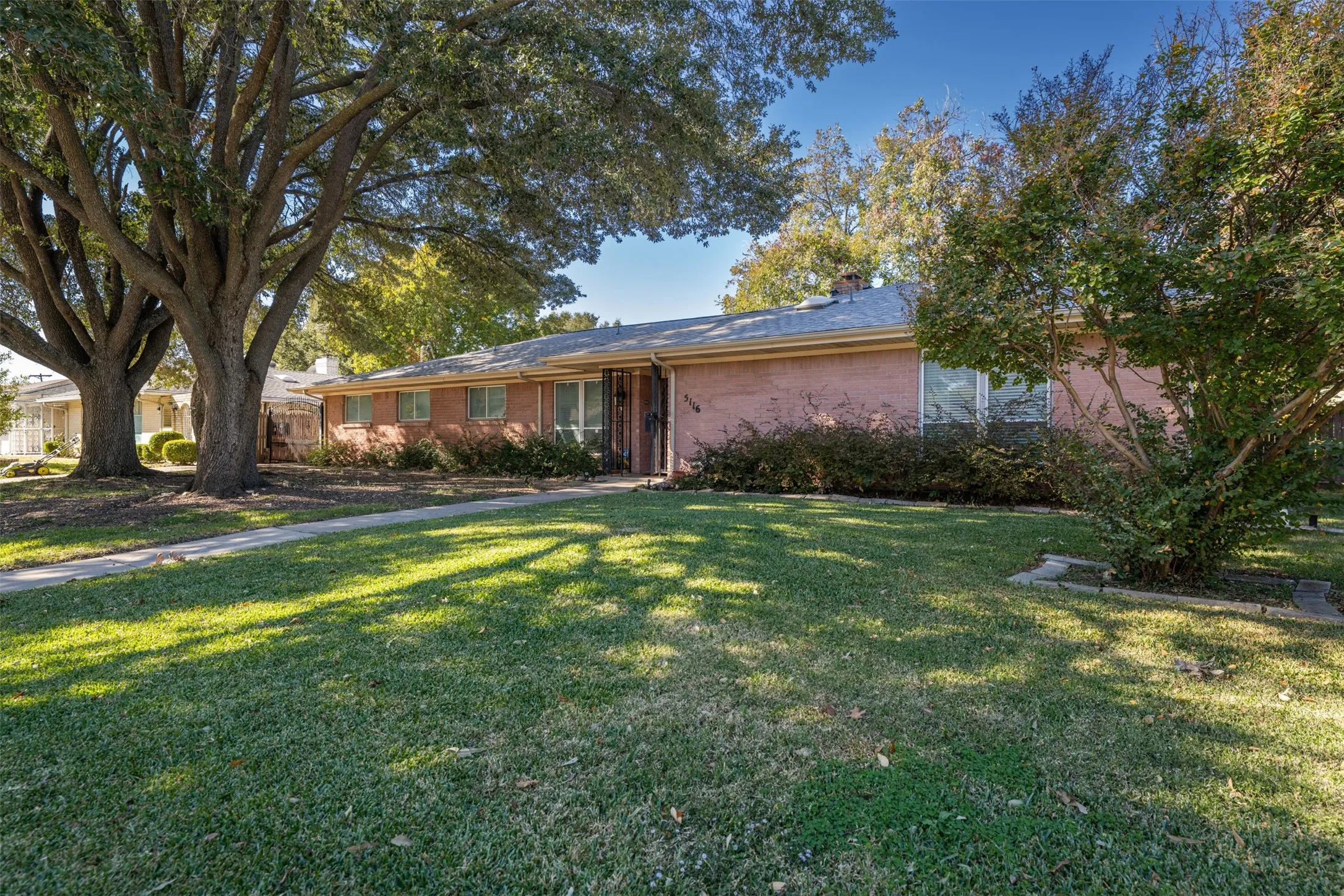 Single story home with brick siding and a front yard