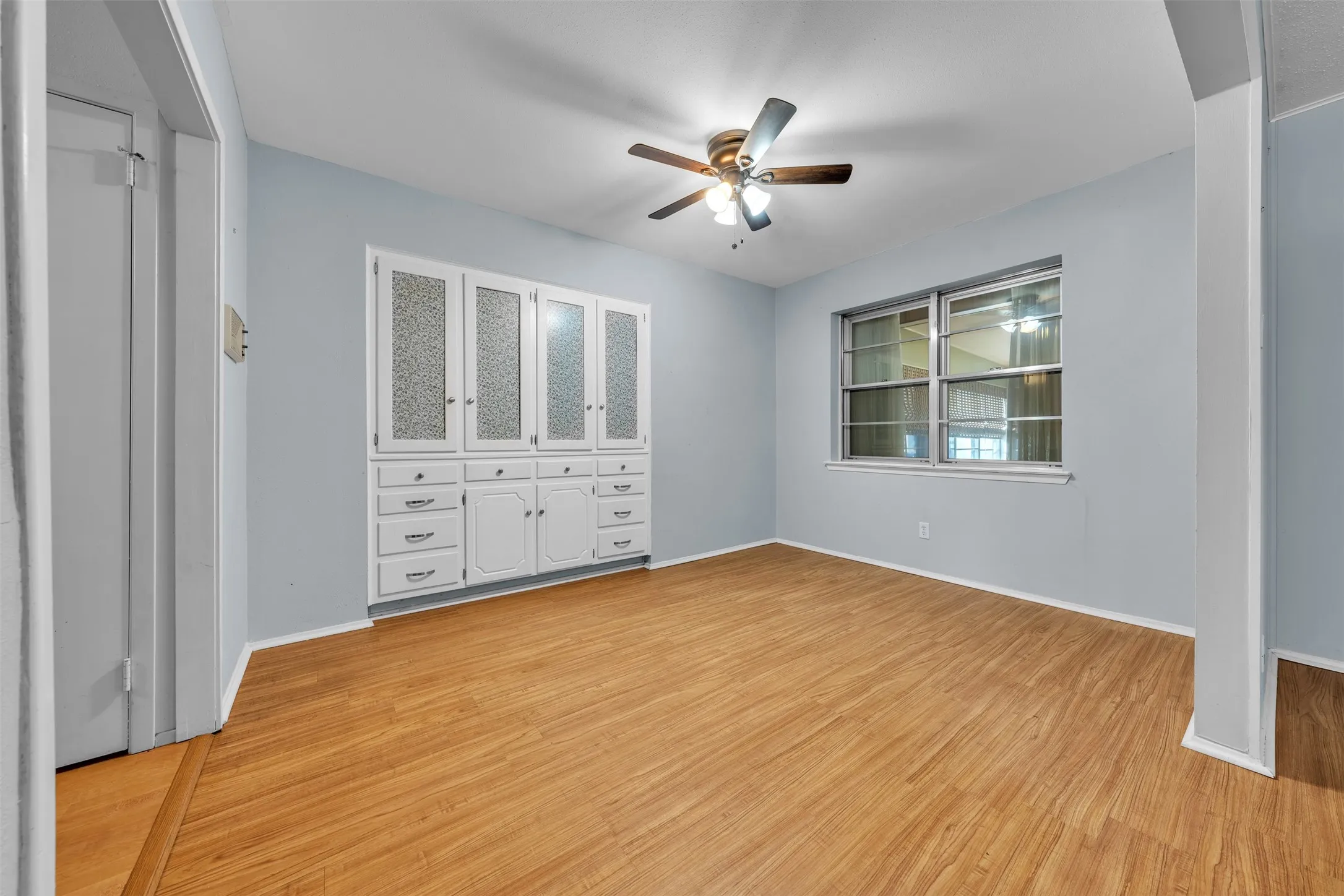 Unfurnished bedroom with light wood-style floors and ceiling fan