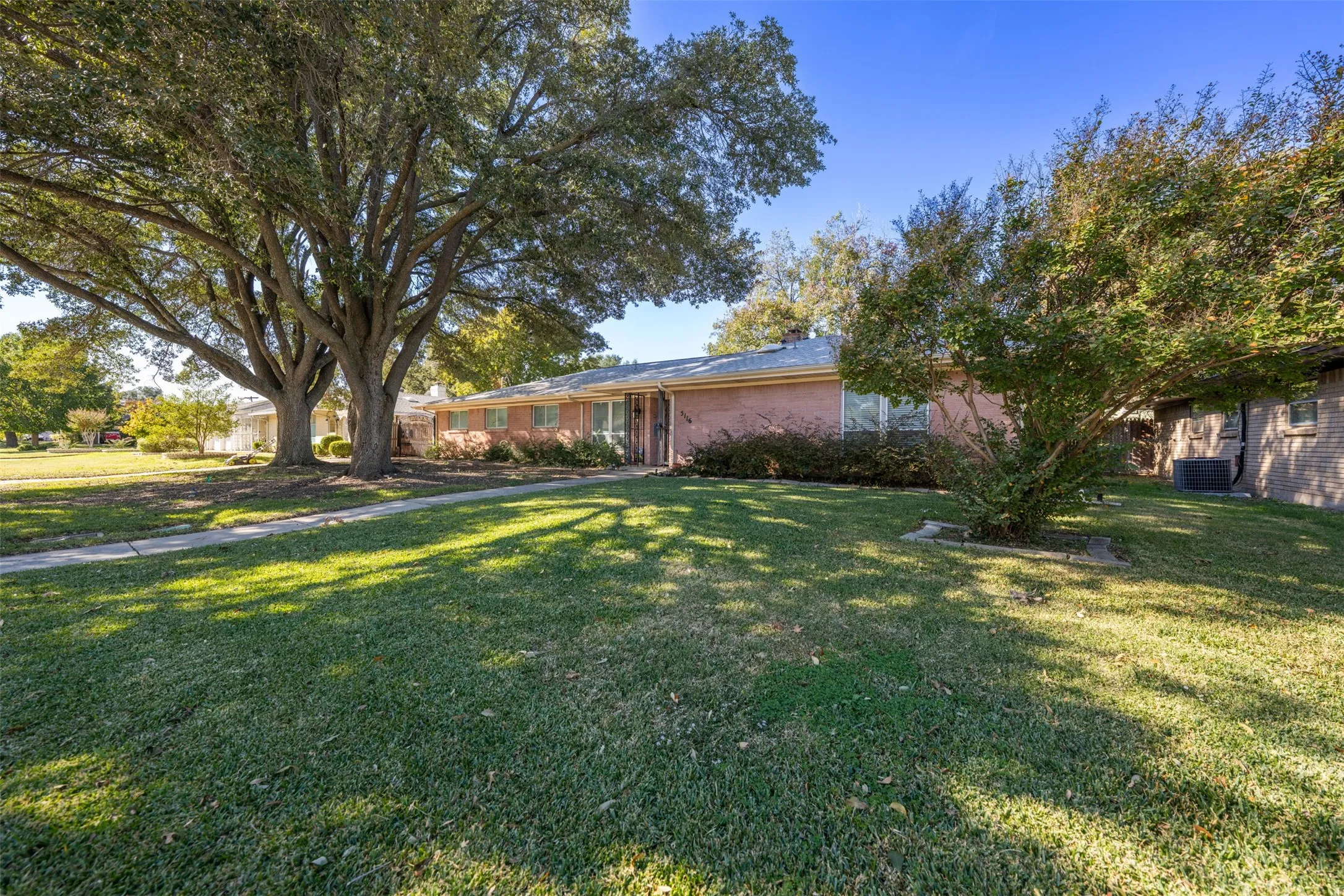 View of front of property featuring a front yard and brick siding