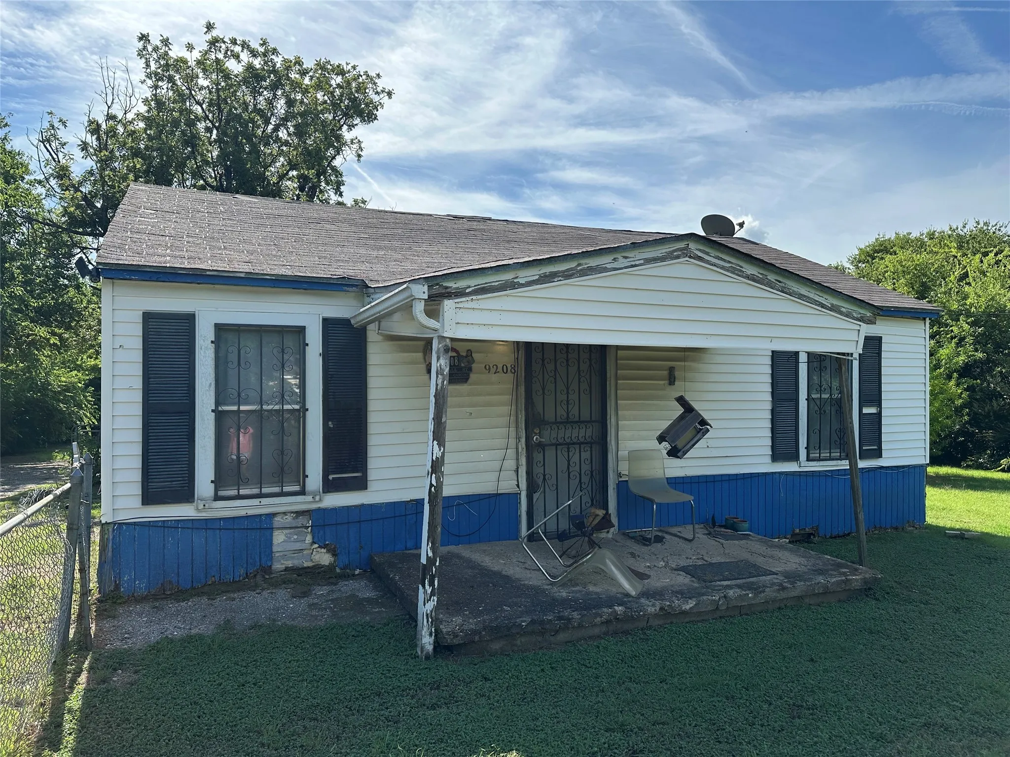 View of front of house with a shingled roof and a front yard