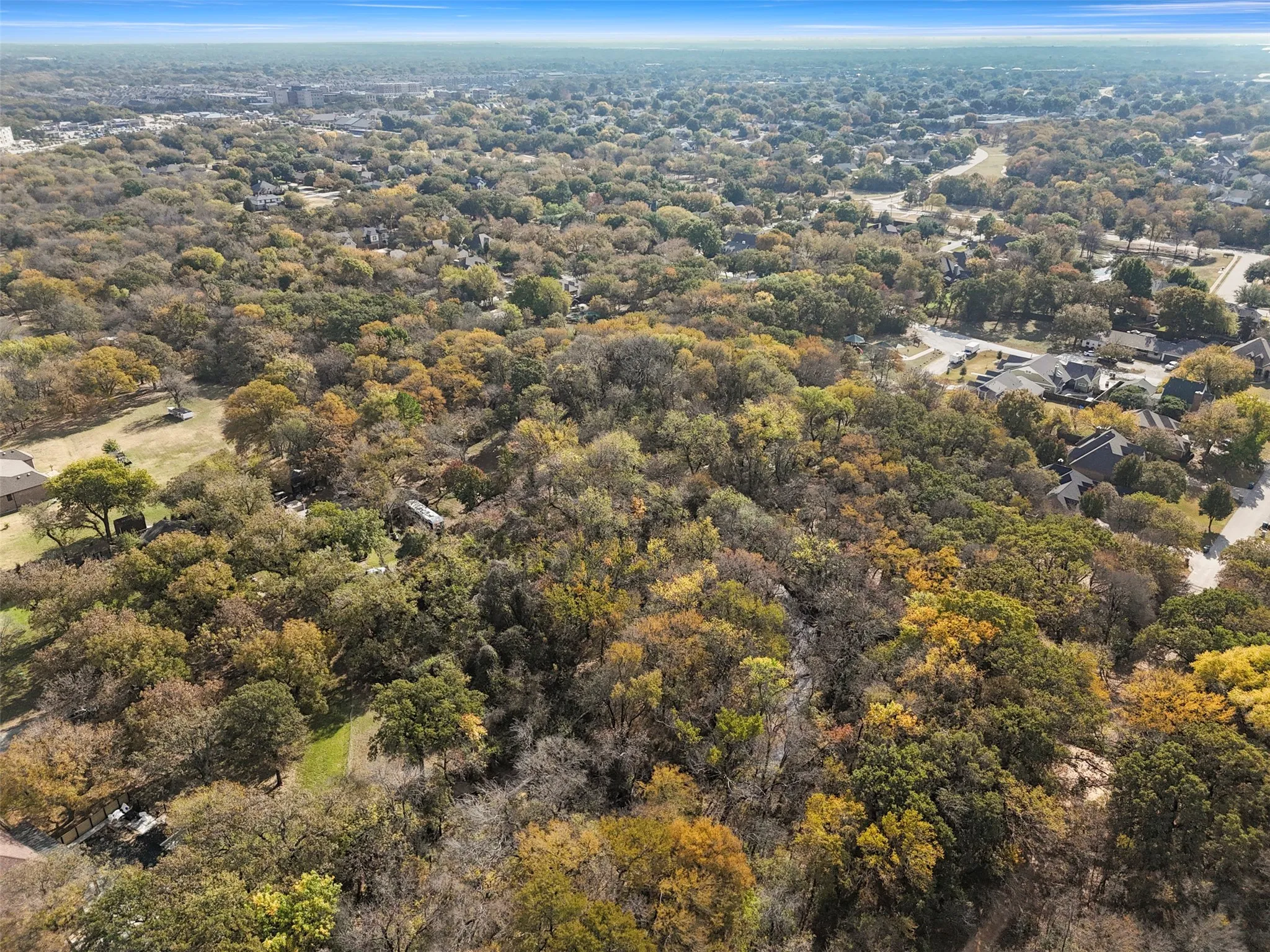 Aerial view of property's location with a forest
