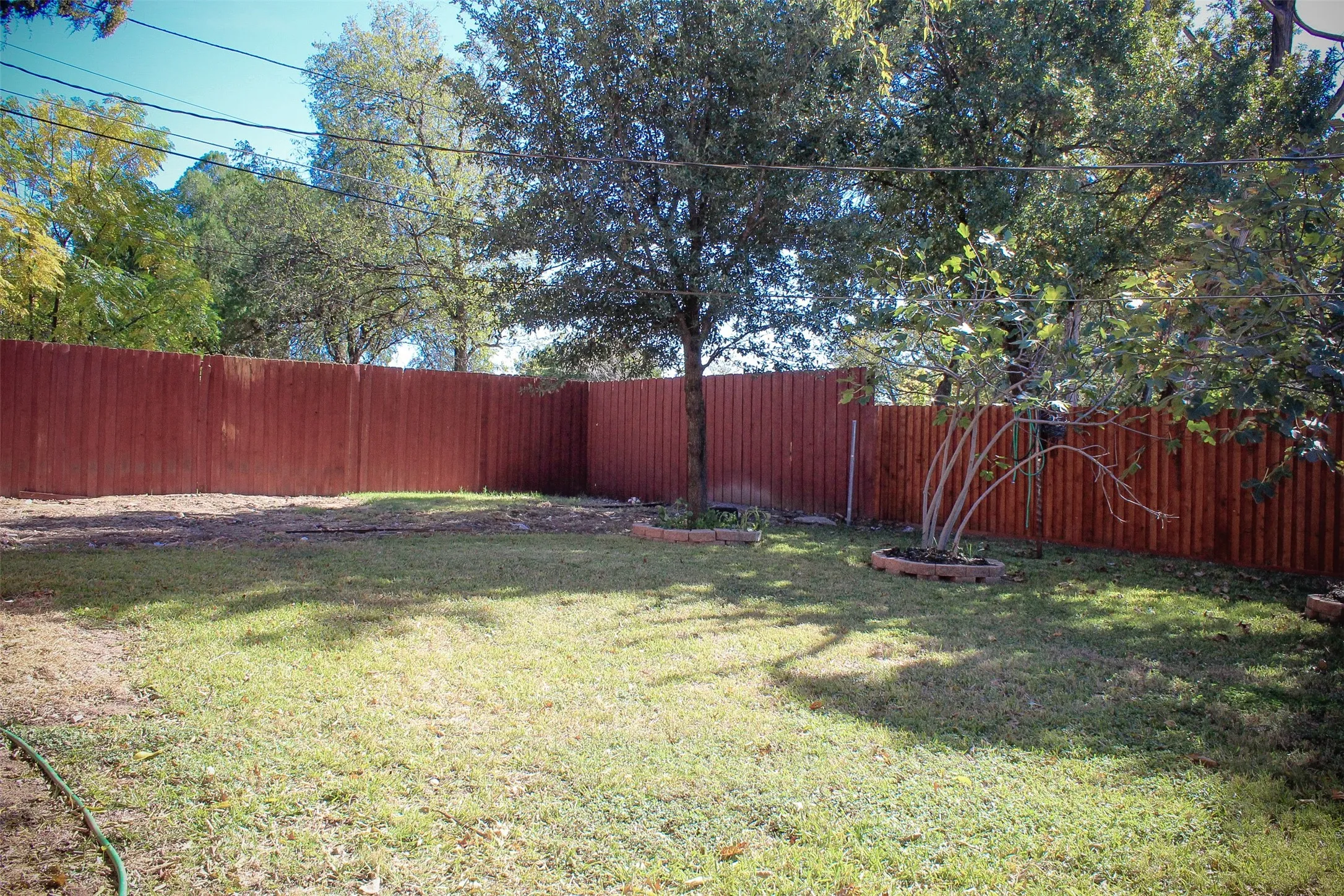 View of fenced backyard