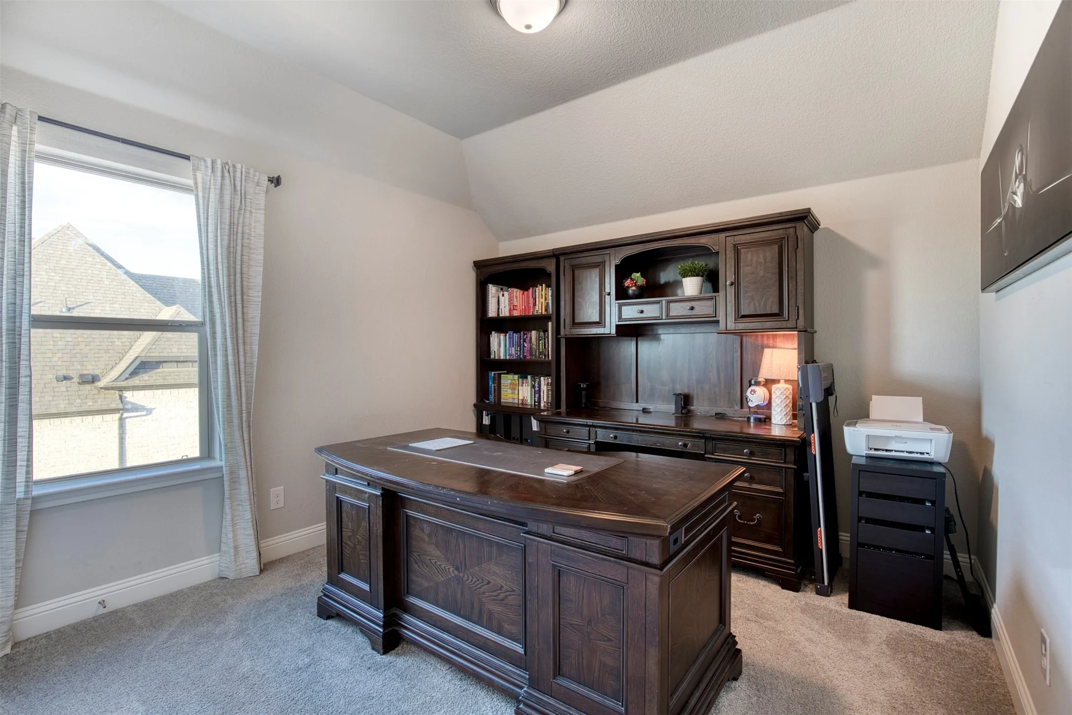 Dedicated upstairs office with sloped ceiling.