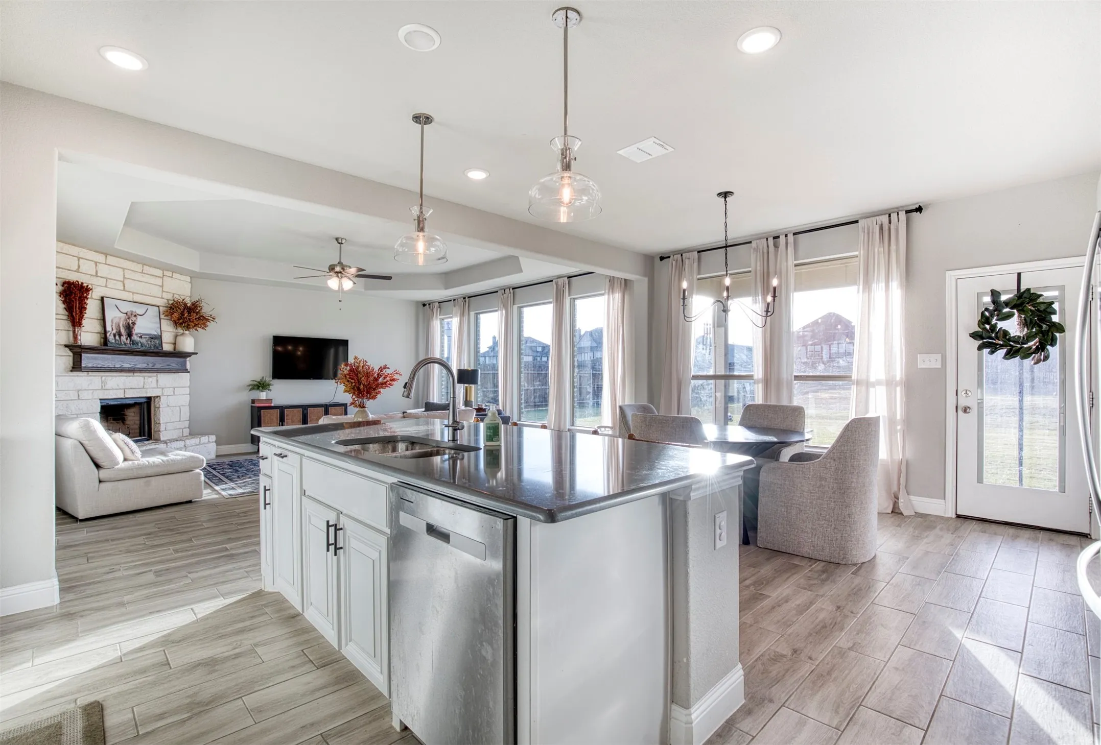 Kitchen with oversized eat-in island with designer pendant lighting.