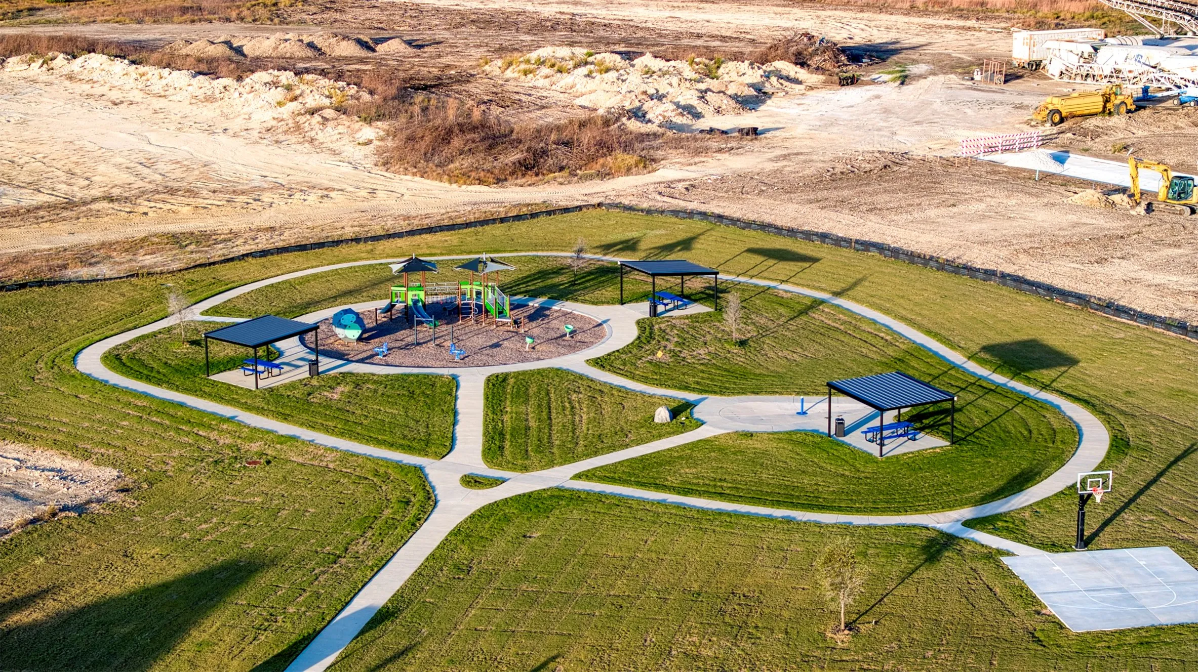 Community area featuing park, walking path, and covered picnic areas.