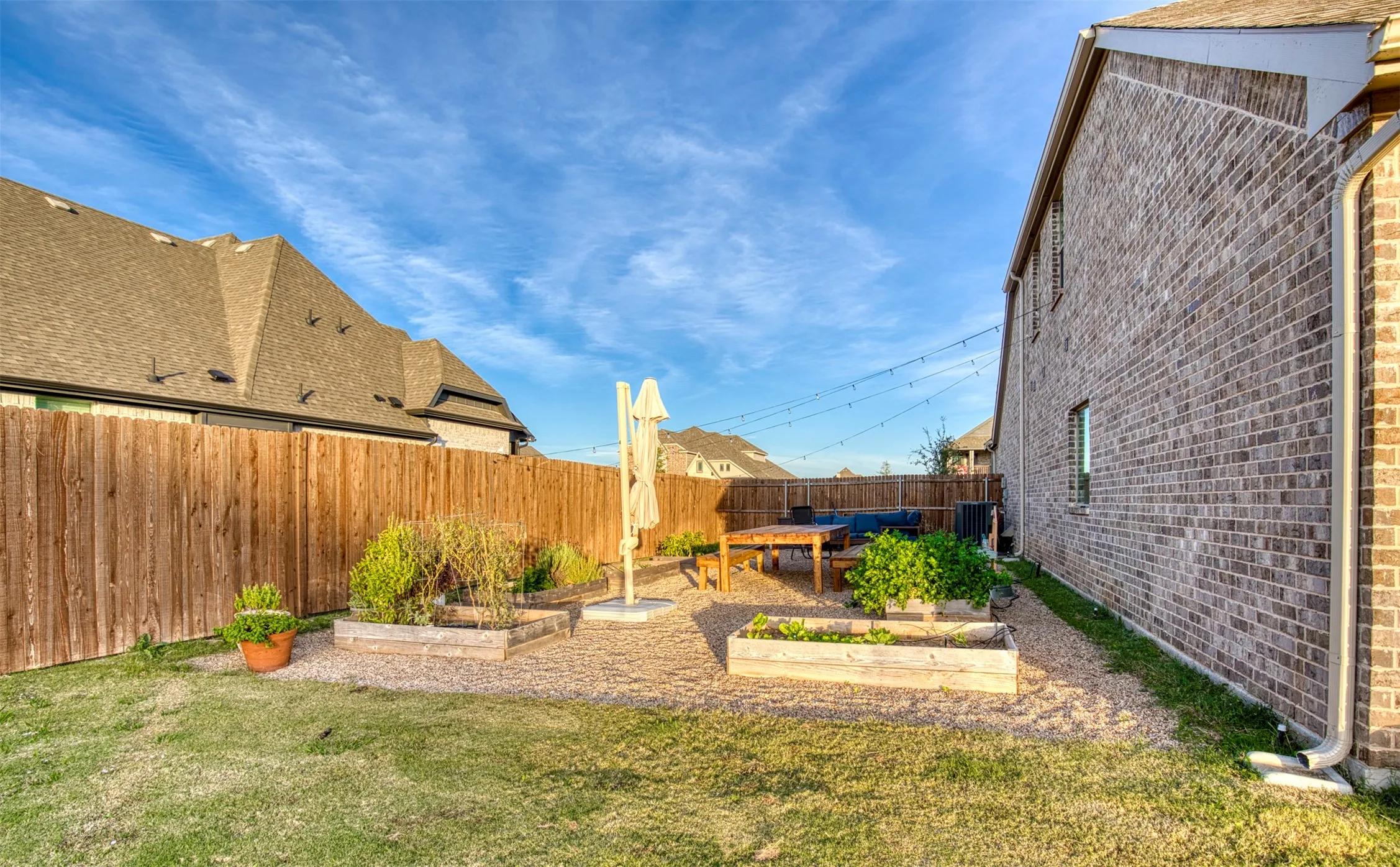 Large side yard boasting garden courtyard with watering system.
