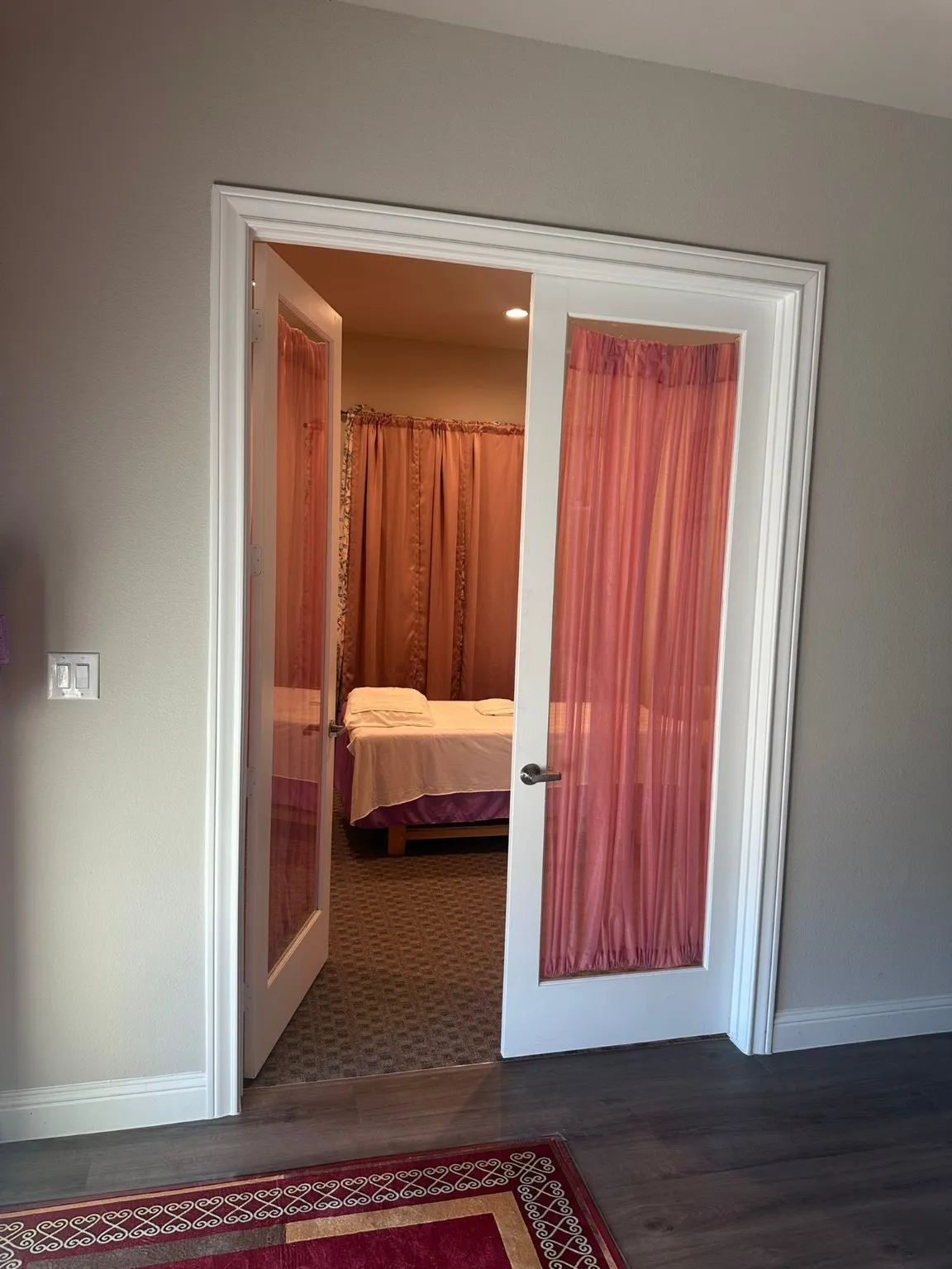 Hall with french doors and dark wood-type flooring