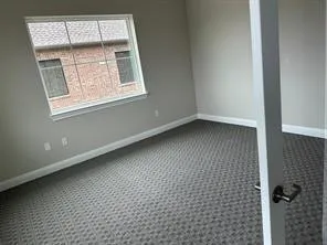 Unfurnished room with baseboards and carpet flooring