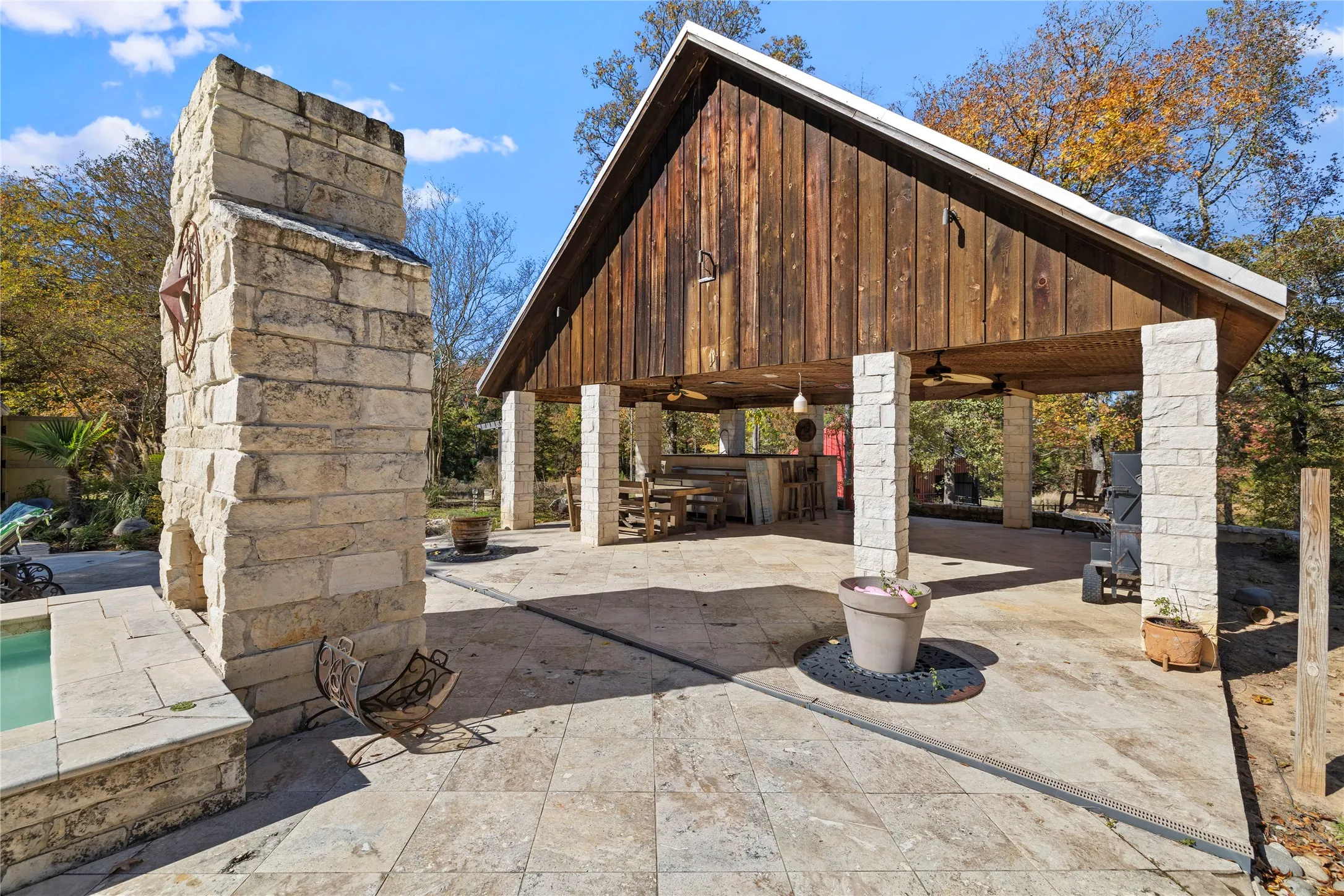 View of patio with ceiling fan and a pool