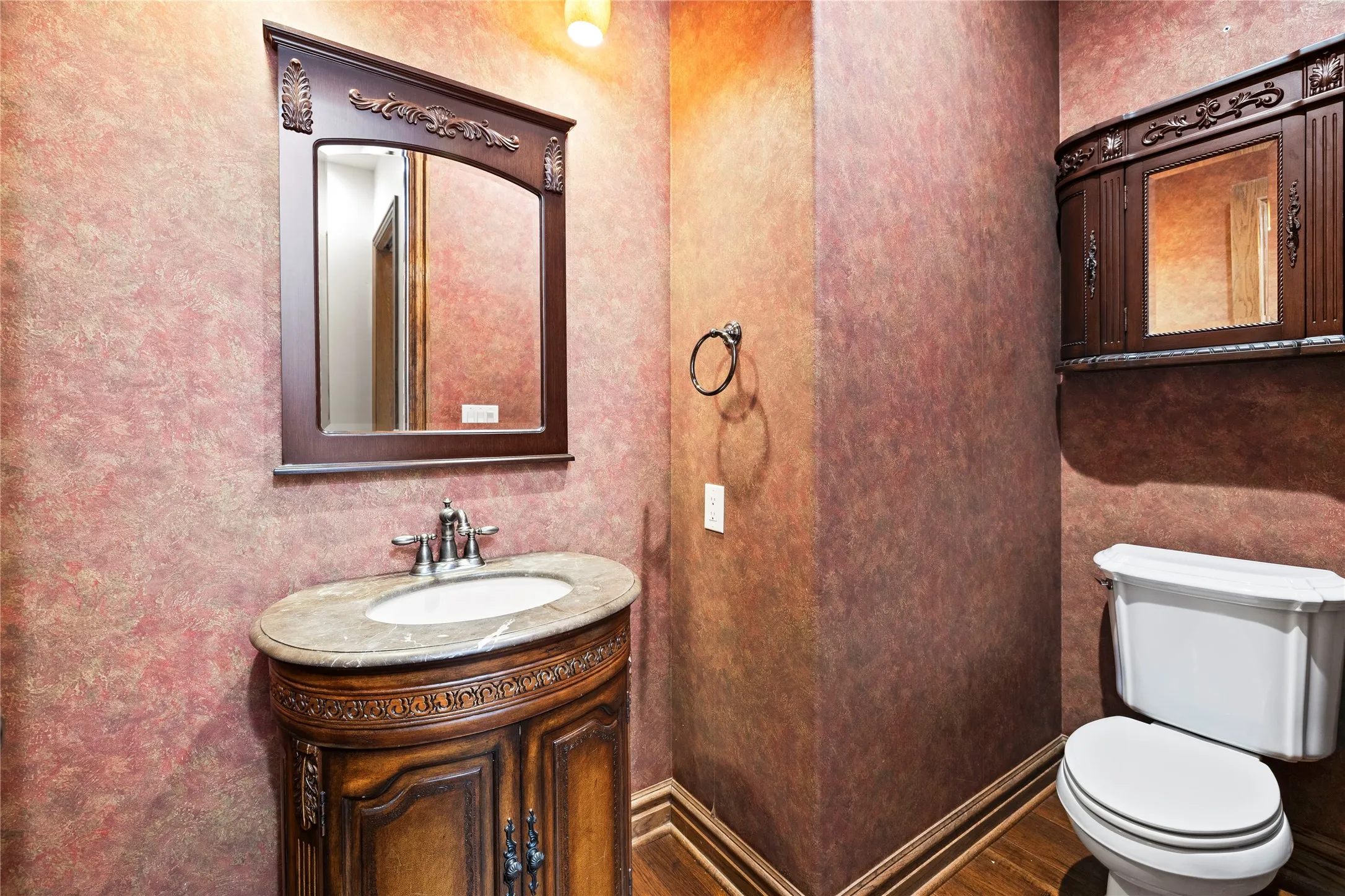 Half bathroom featuring vanity and toilet