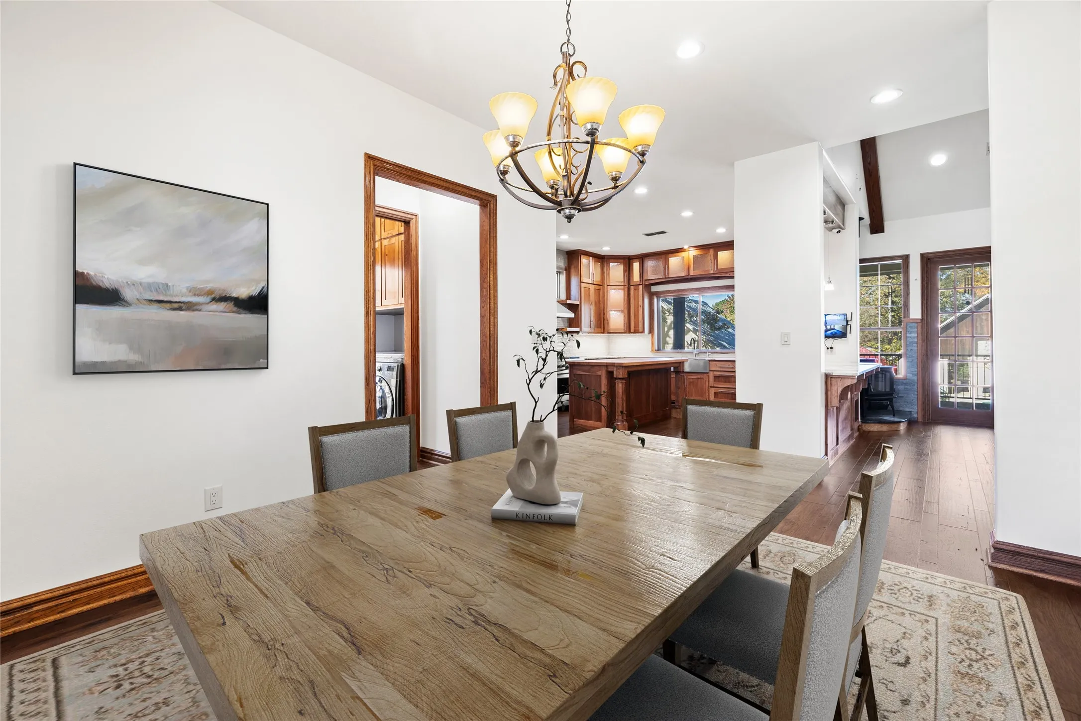 Dining area with recessed lighting, dark wood-type flooring, a chandelier, and washer / dryer