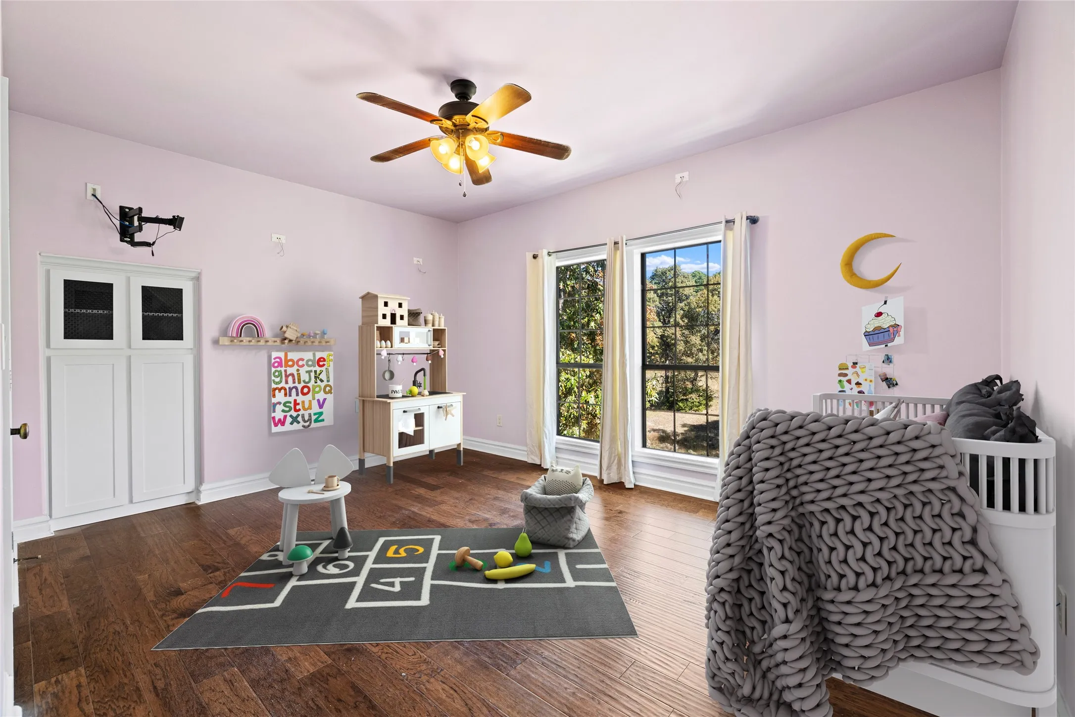 Bedroom featuring wood finished floors and ceiling fan