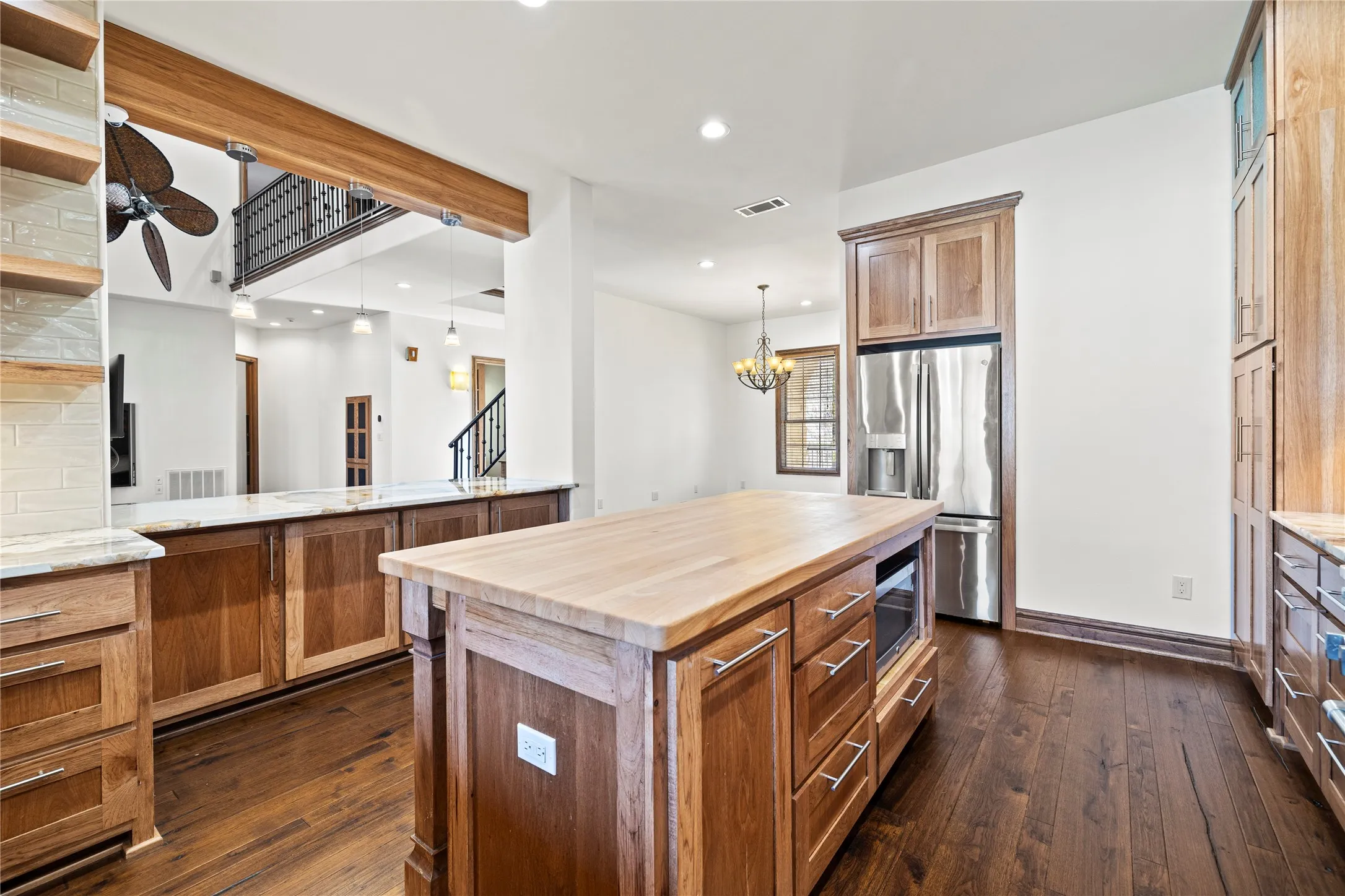 Kitchen featuring wood counters, brown cabinets, stainless steel appliances, recessed lighting, and dark wood-type flooring