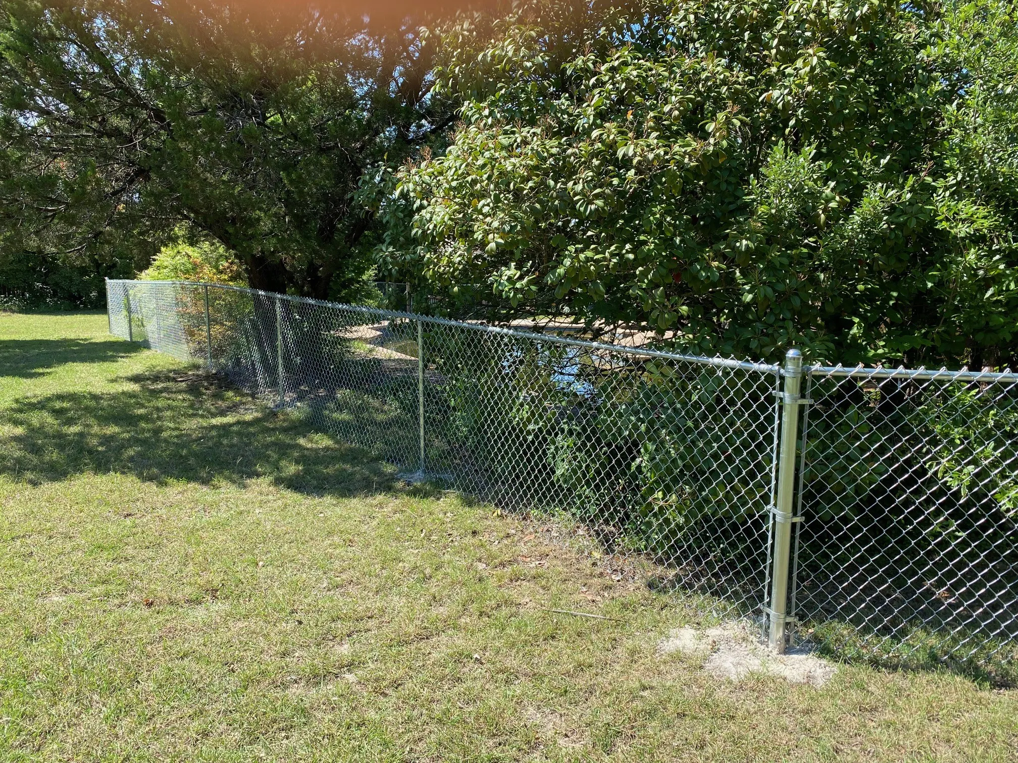 New chain link fence surrounds pool and makes a good dog run