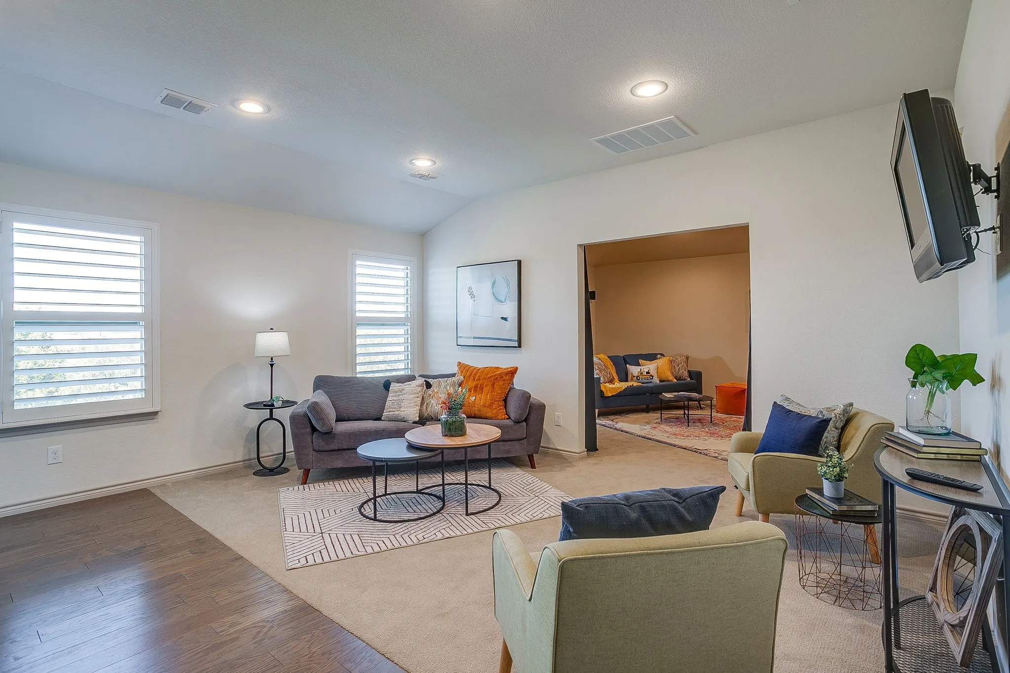 Living room featuring lofted ceiling, recessed lighting, and wood finished floors