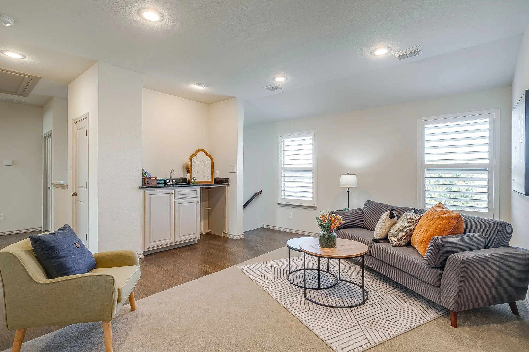 Living area featuring wood finished floors, recessed lighting, and attic access