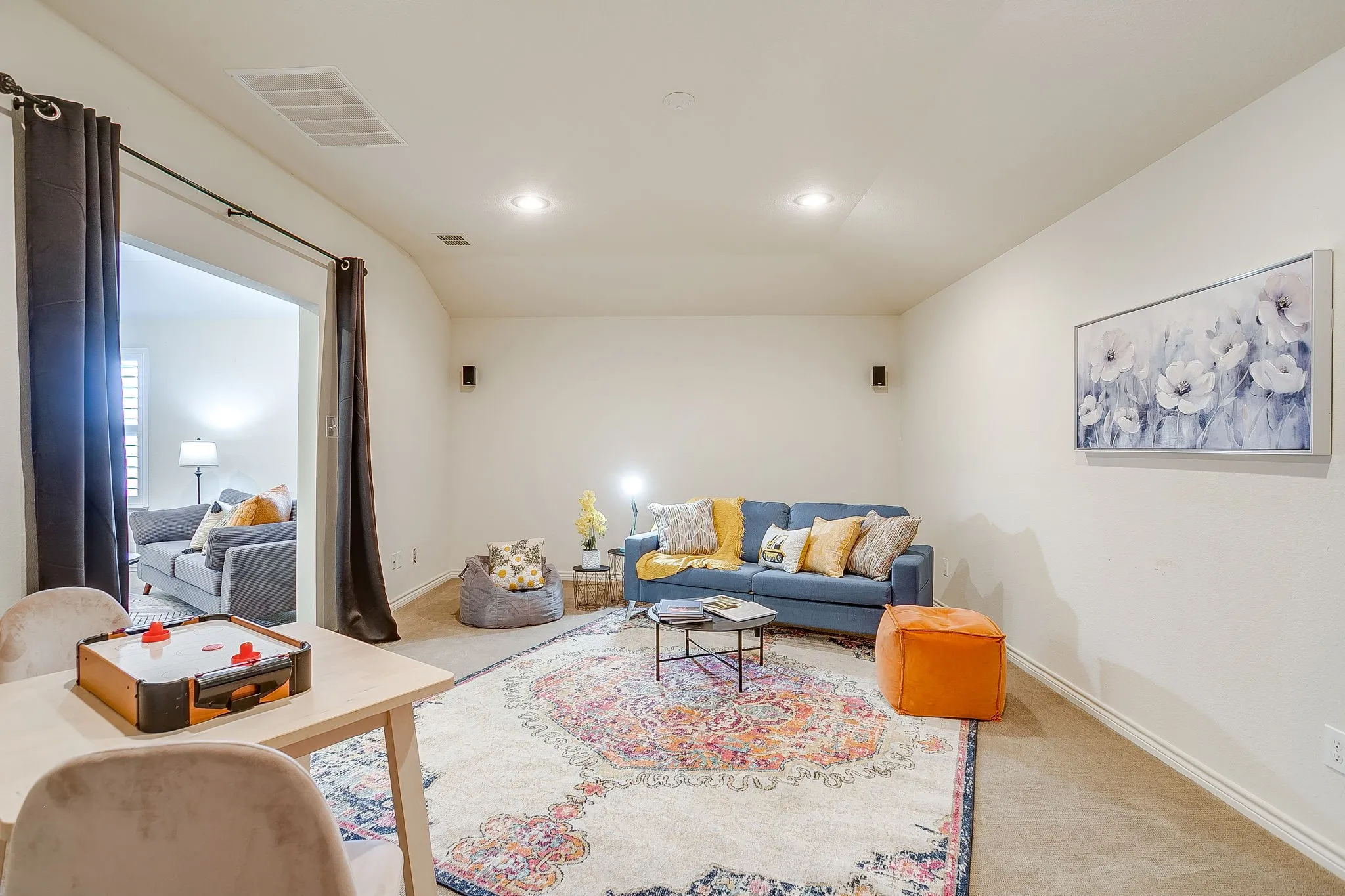 Living area with carpet and recessed lighting