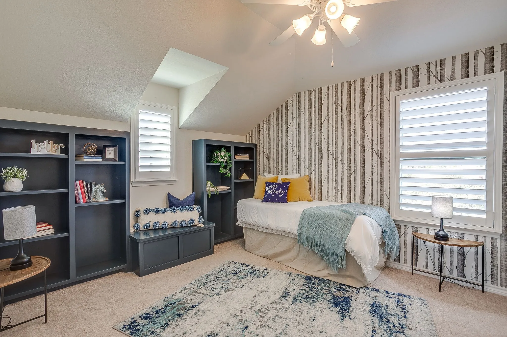 Bedroom featuring wallpapered walls, light colored carpet, ceiling fan, and lofted ceiling