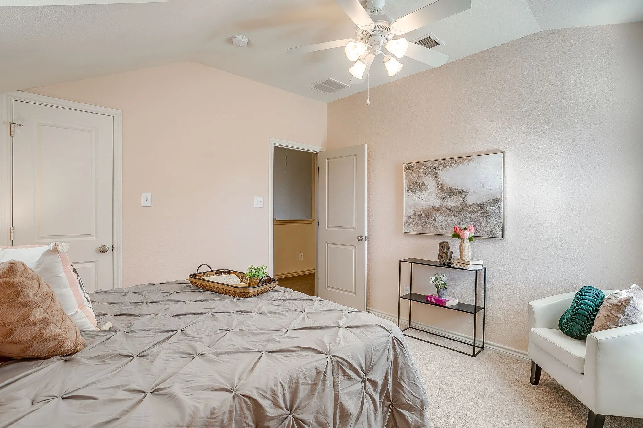 Bedroom with lofted ceiling, light colored carpet, and ceiling fan