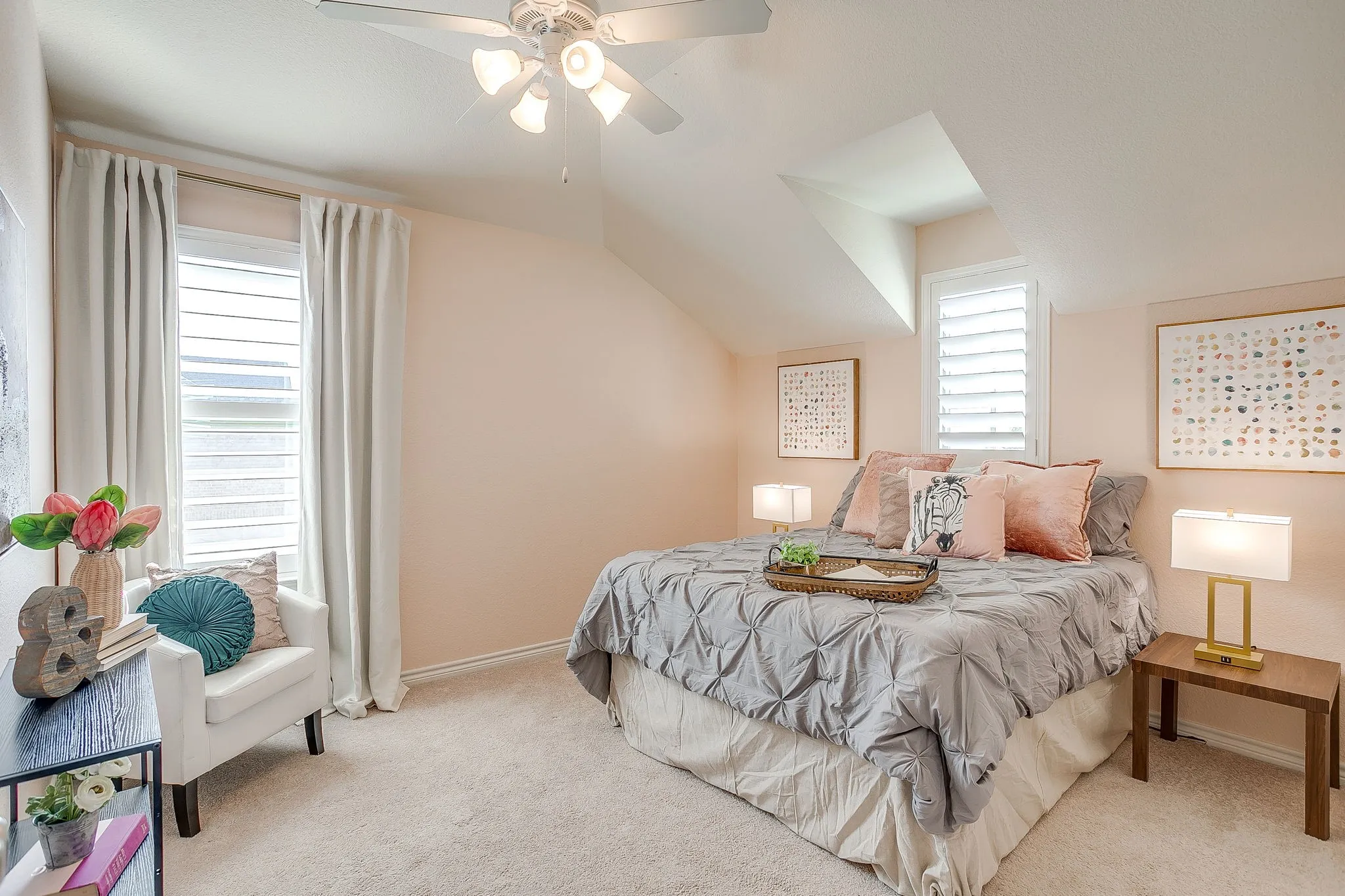 Carpeted bedroom with vaulted ceiling and a ceiling fan