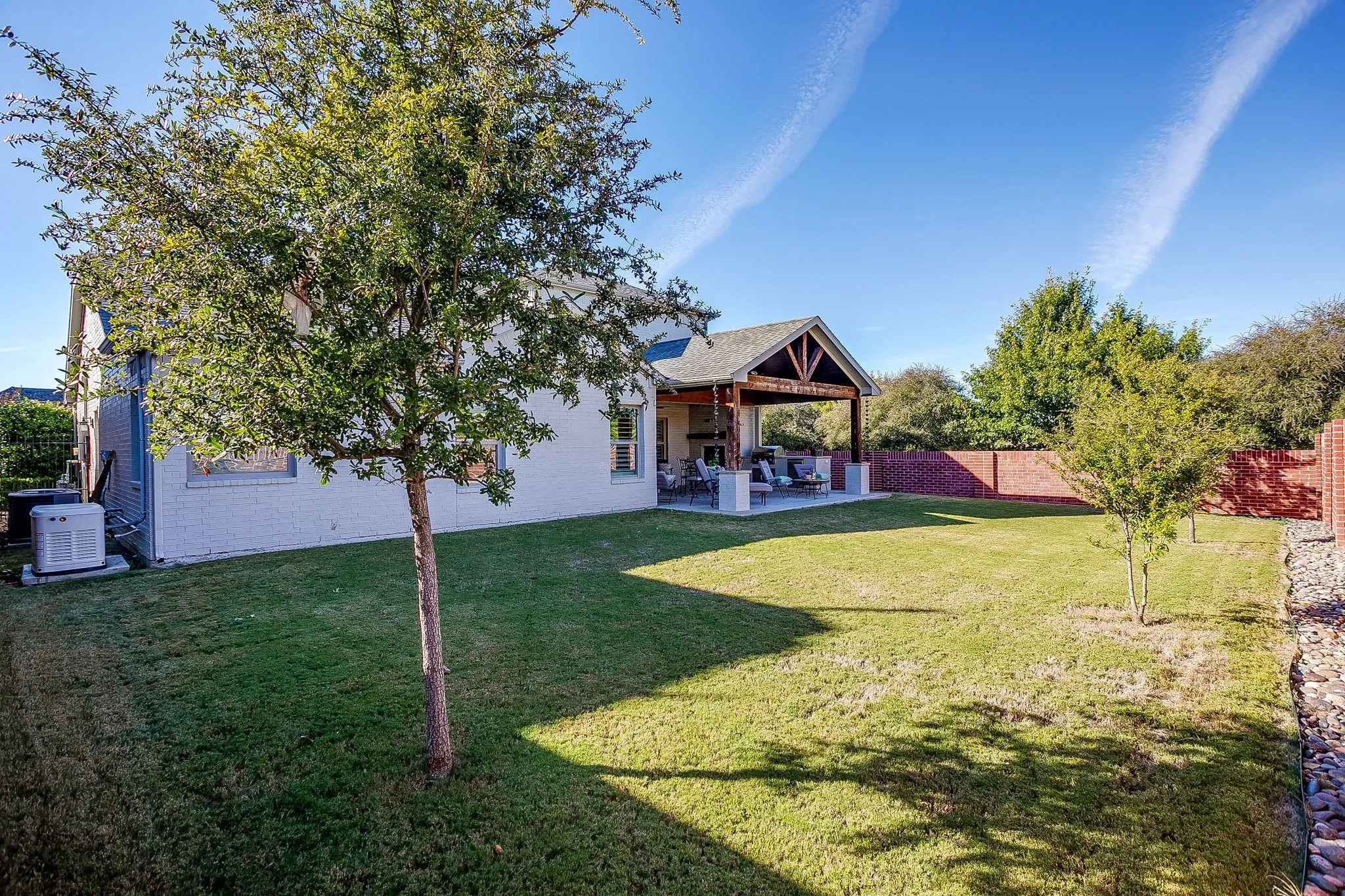 Rear view of property with a patio and a fenced backyard