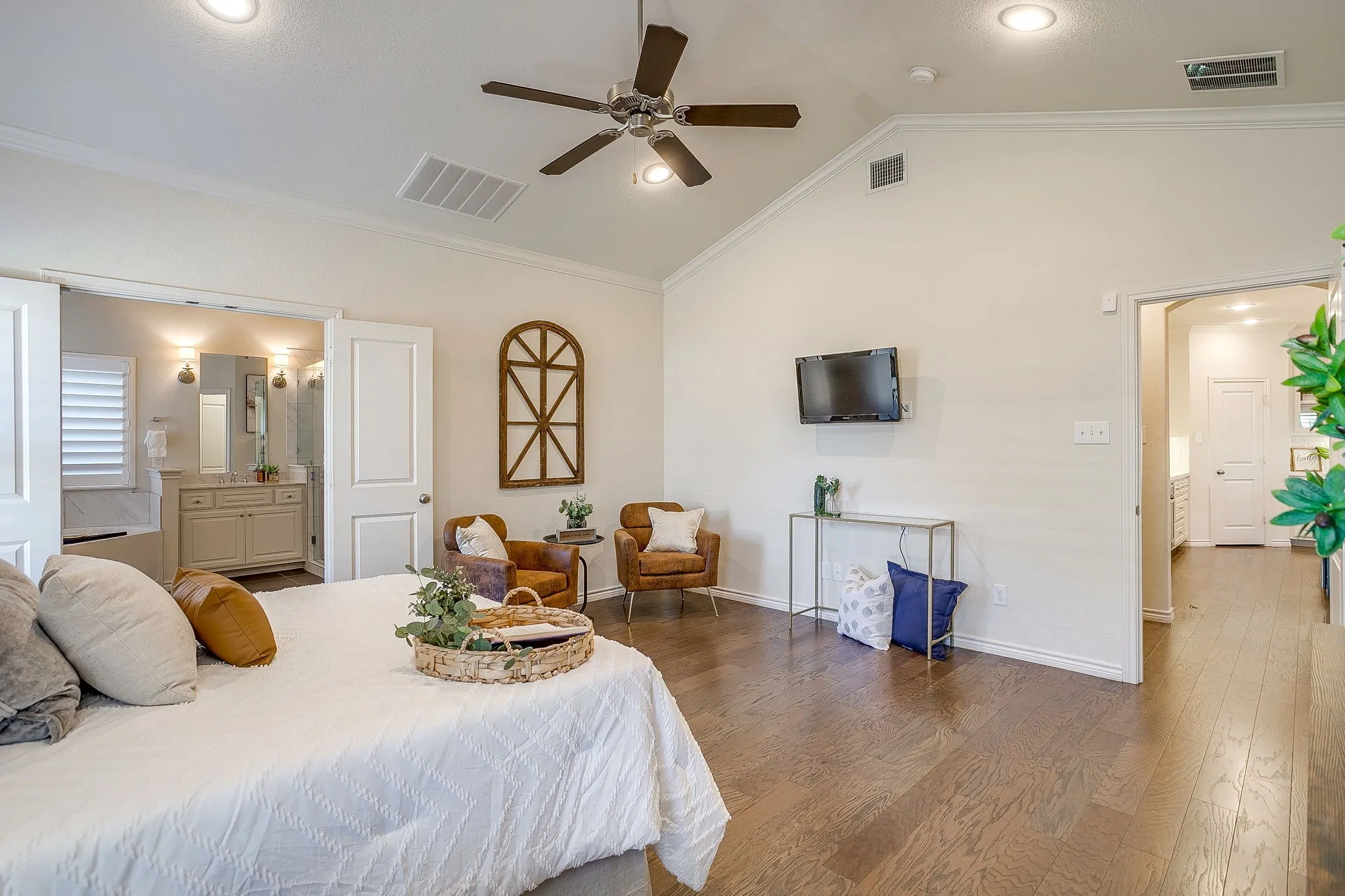 Bedroom with wood finished floors, ornamental molding, ensuite bath, recessed lighting, and a ceiling fan