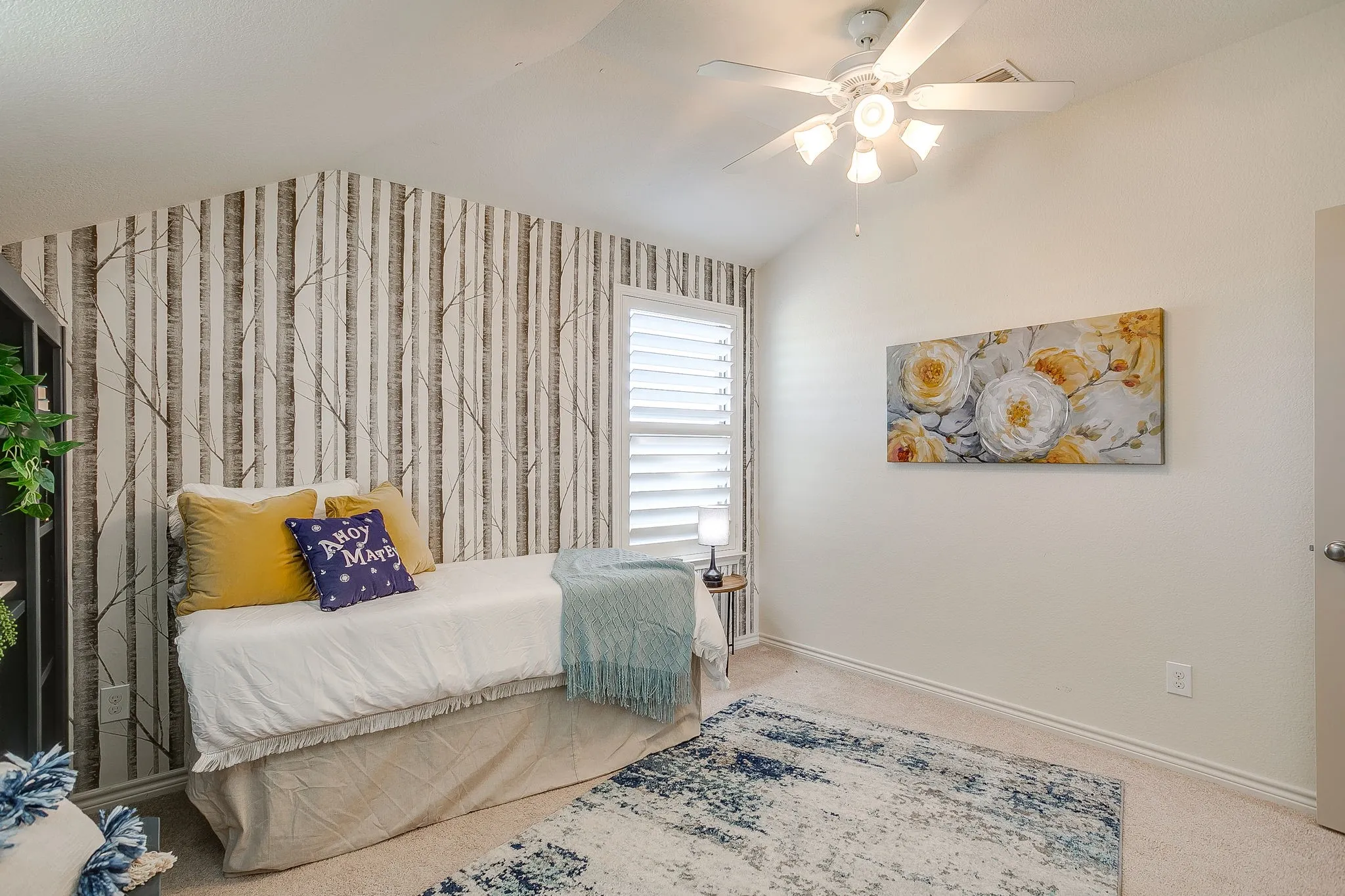 Carpeted bedroom with vaulted ceiling and a ceiling fan