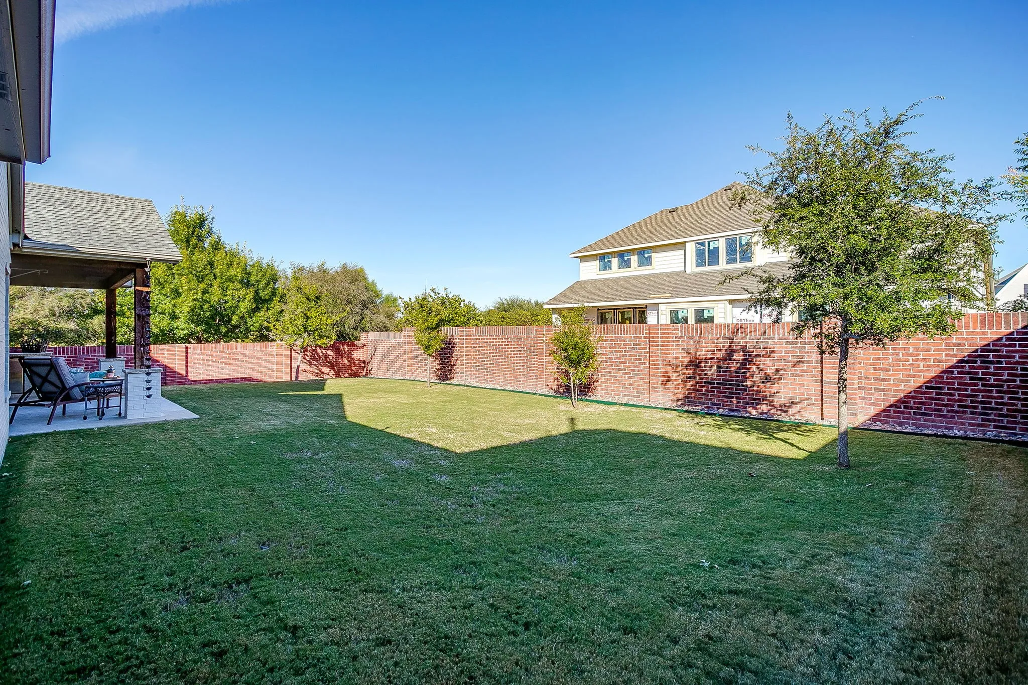 Fenced backyard with a patio