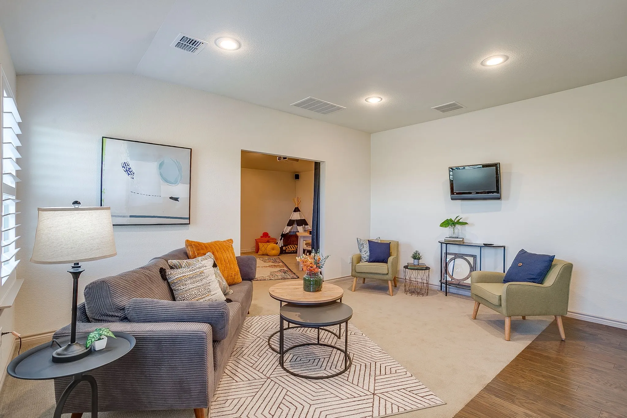 Living room featuring recessed lighting, wood finished floors, and lofted ceiling