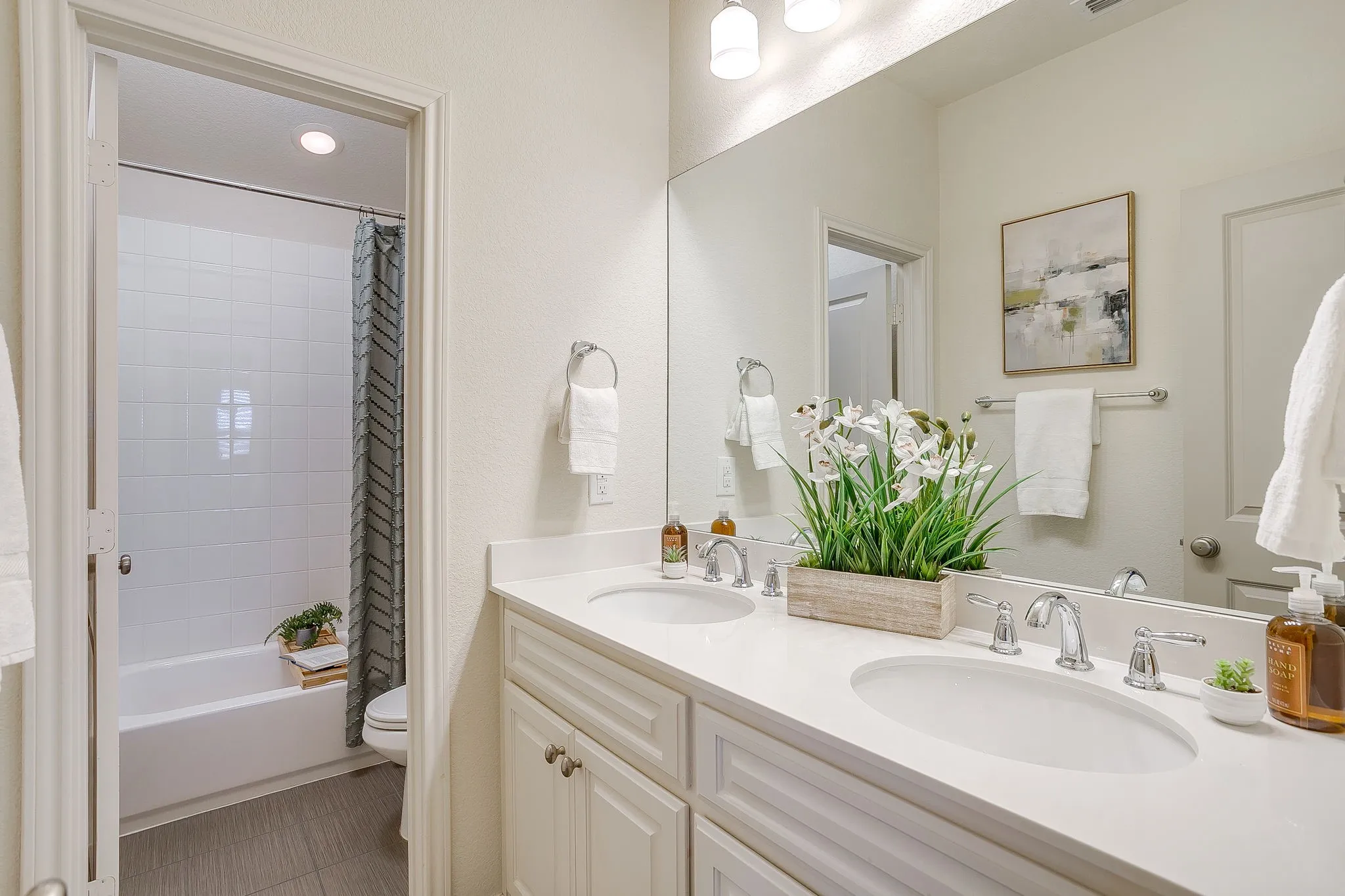 Full bathroom featuring double vanity, shower / bath combination with curtain, light tile patterned flooring, and recessed lighting
