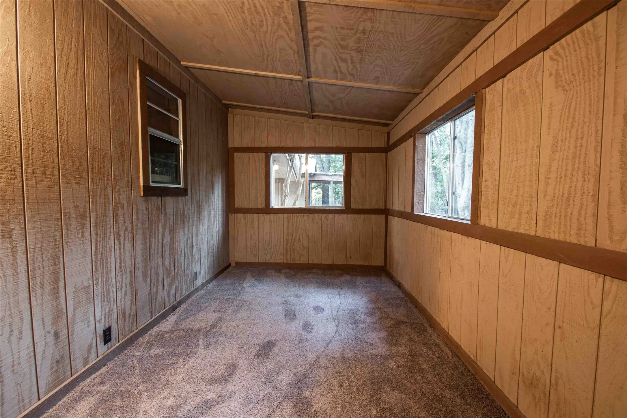 Unfurnished bedroom with lofted ceiling