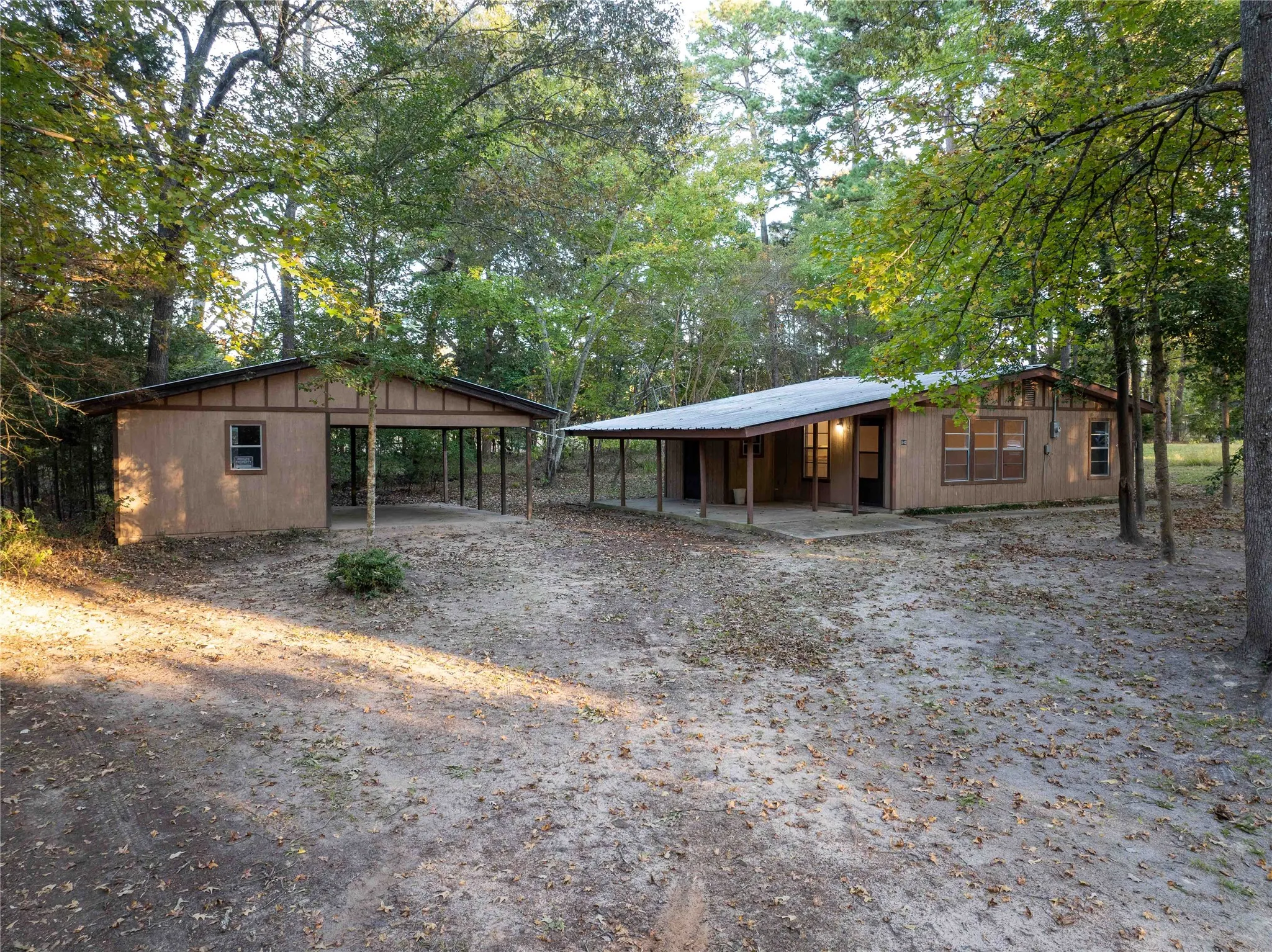 View of the home and outside storage and carport