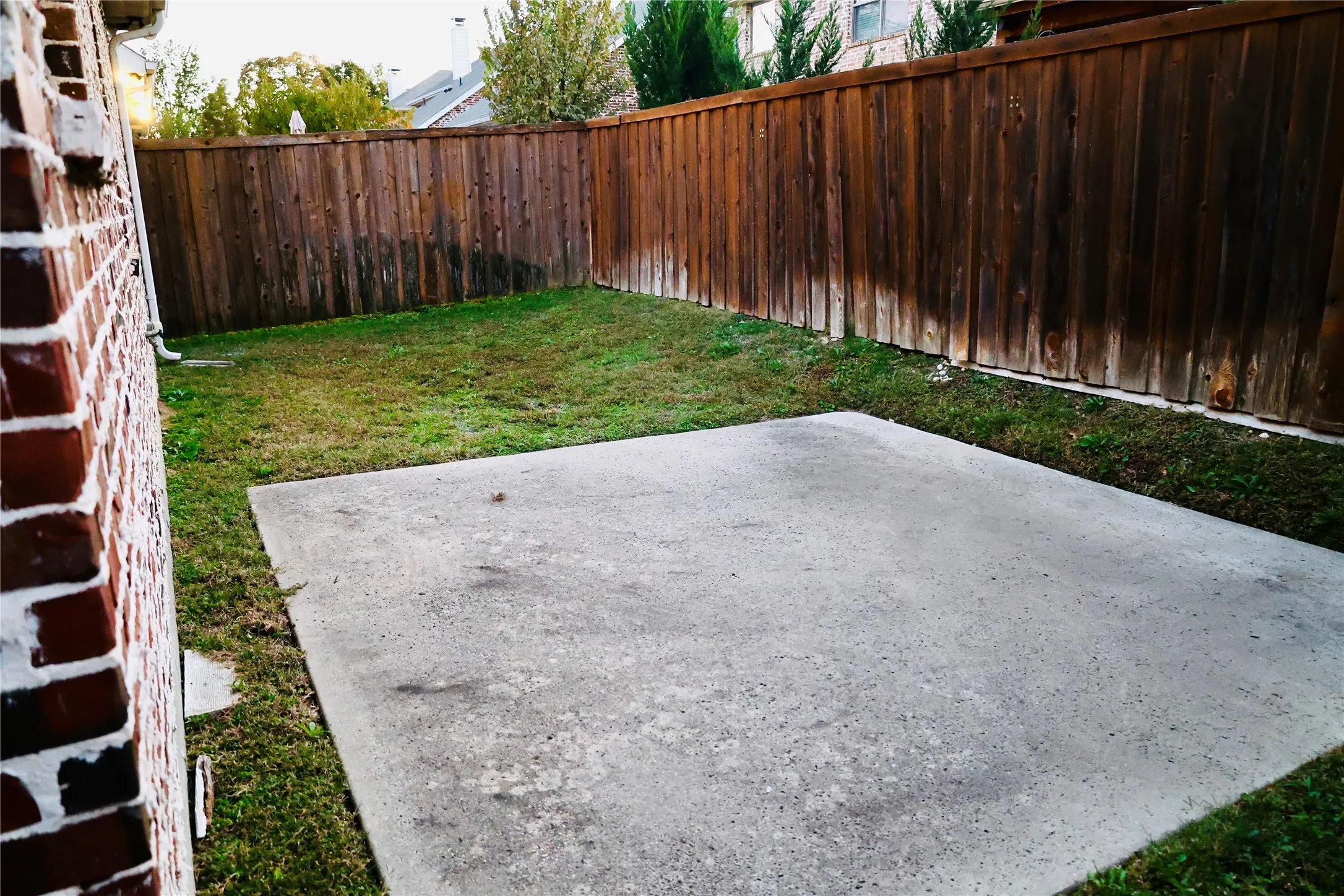 Fenced backyard with a patio area