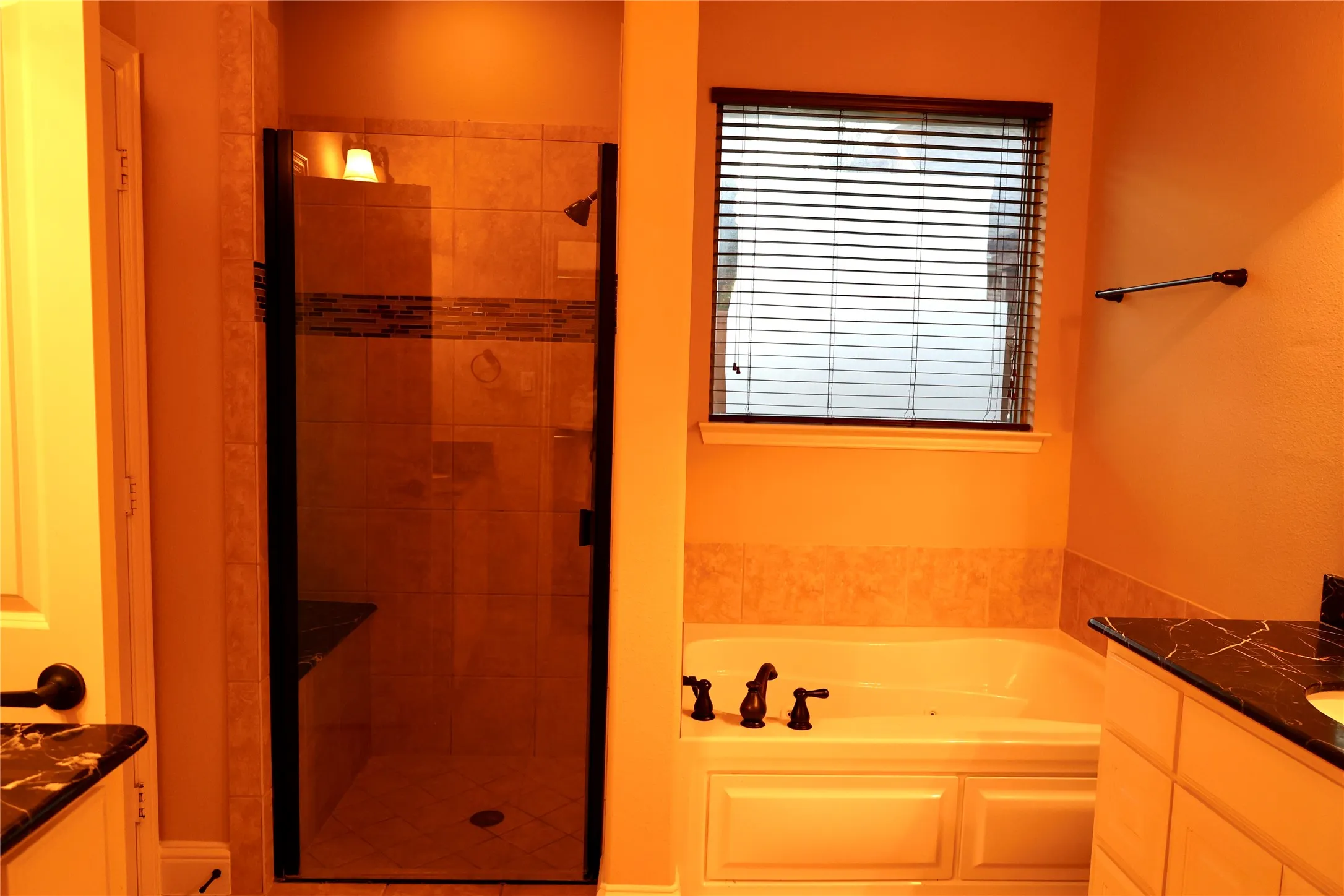 Full bath featuring vanity, a bath, and a shower stall