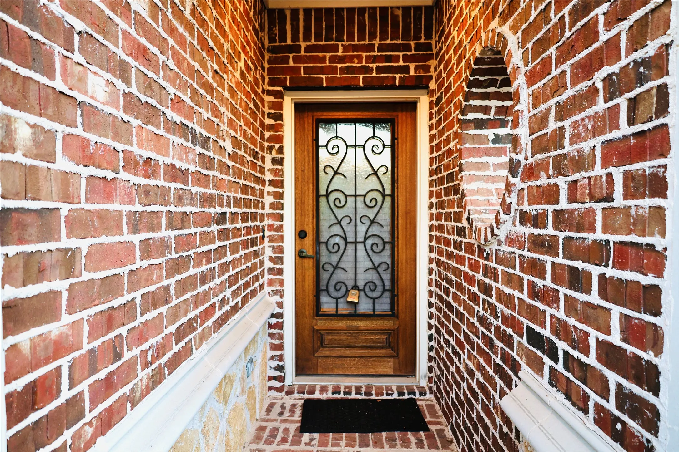 Entrance to property featuring brick siding