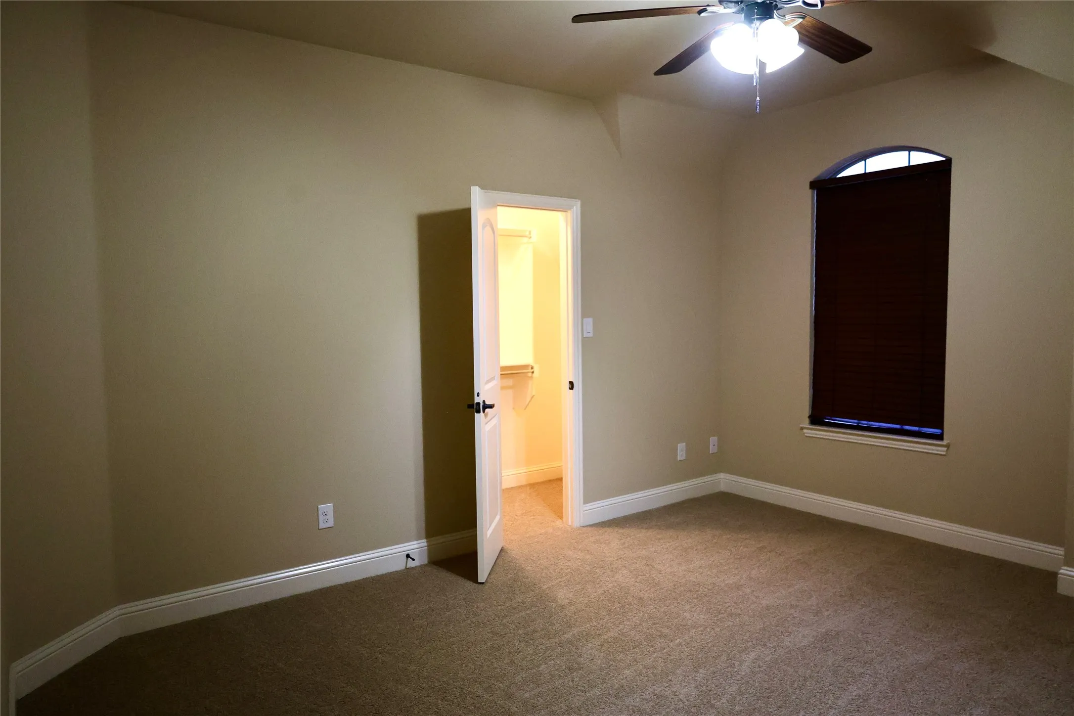 Spare room with carpet floors and ceiling fan