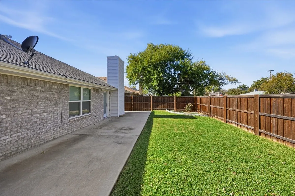 Fenced backyard with a patio area