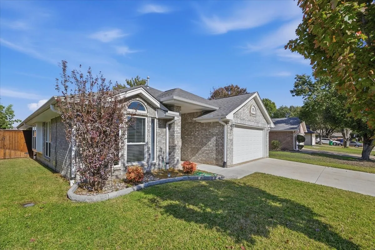 Ranch-style home featuring brick siding, concrete driveway, and a garage