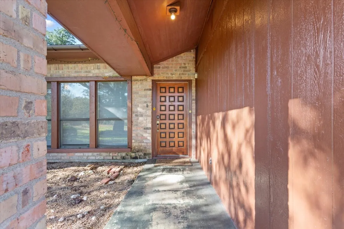 Doorway to property featuring stone siding