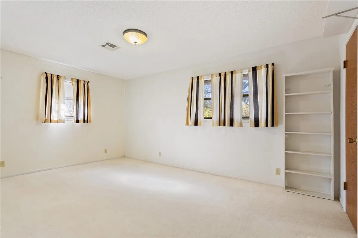 Unfurnished room with carpet