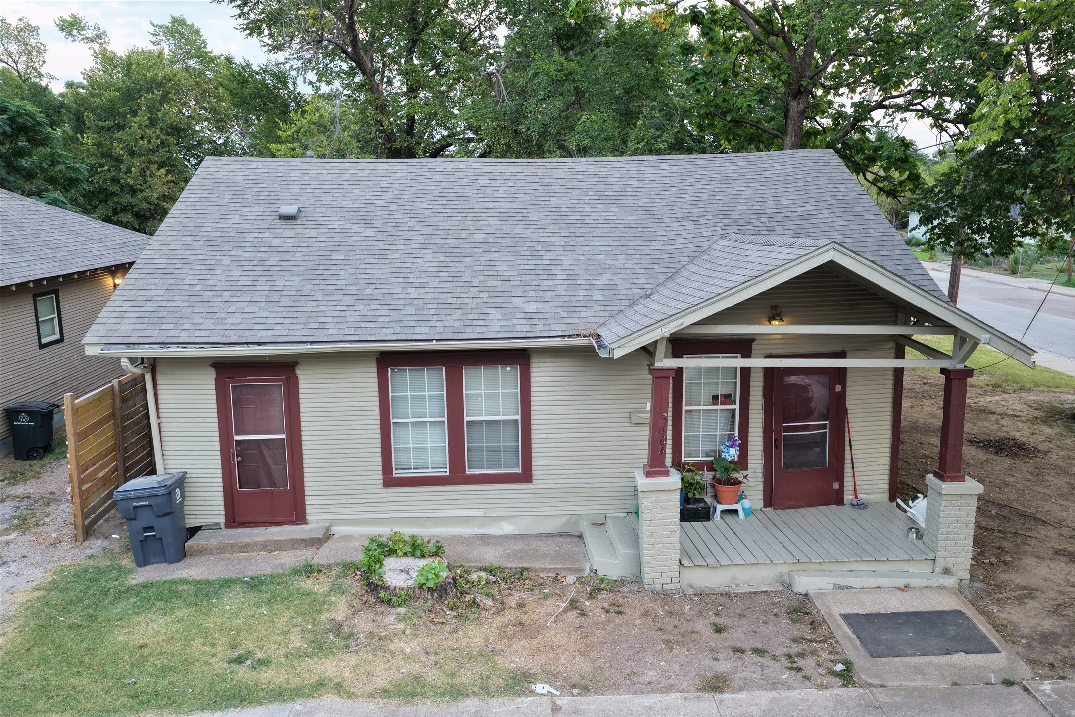 View of front of house featuring roof with shingles and covered porch